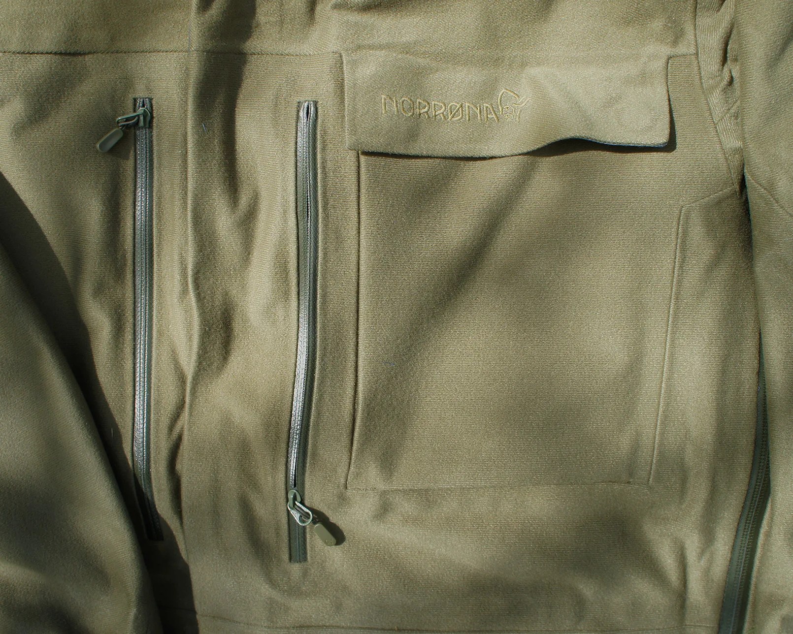 a chest pocket on a green parka