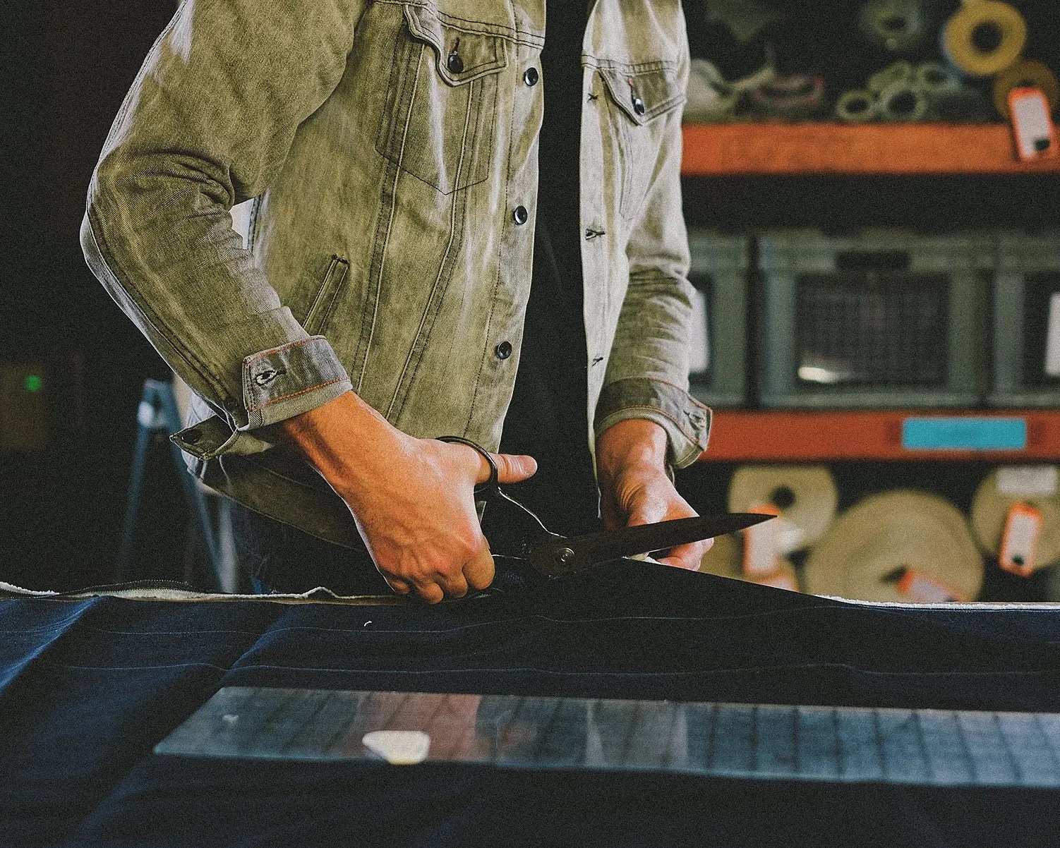 a man cutting denim