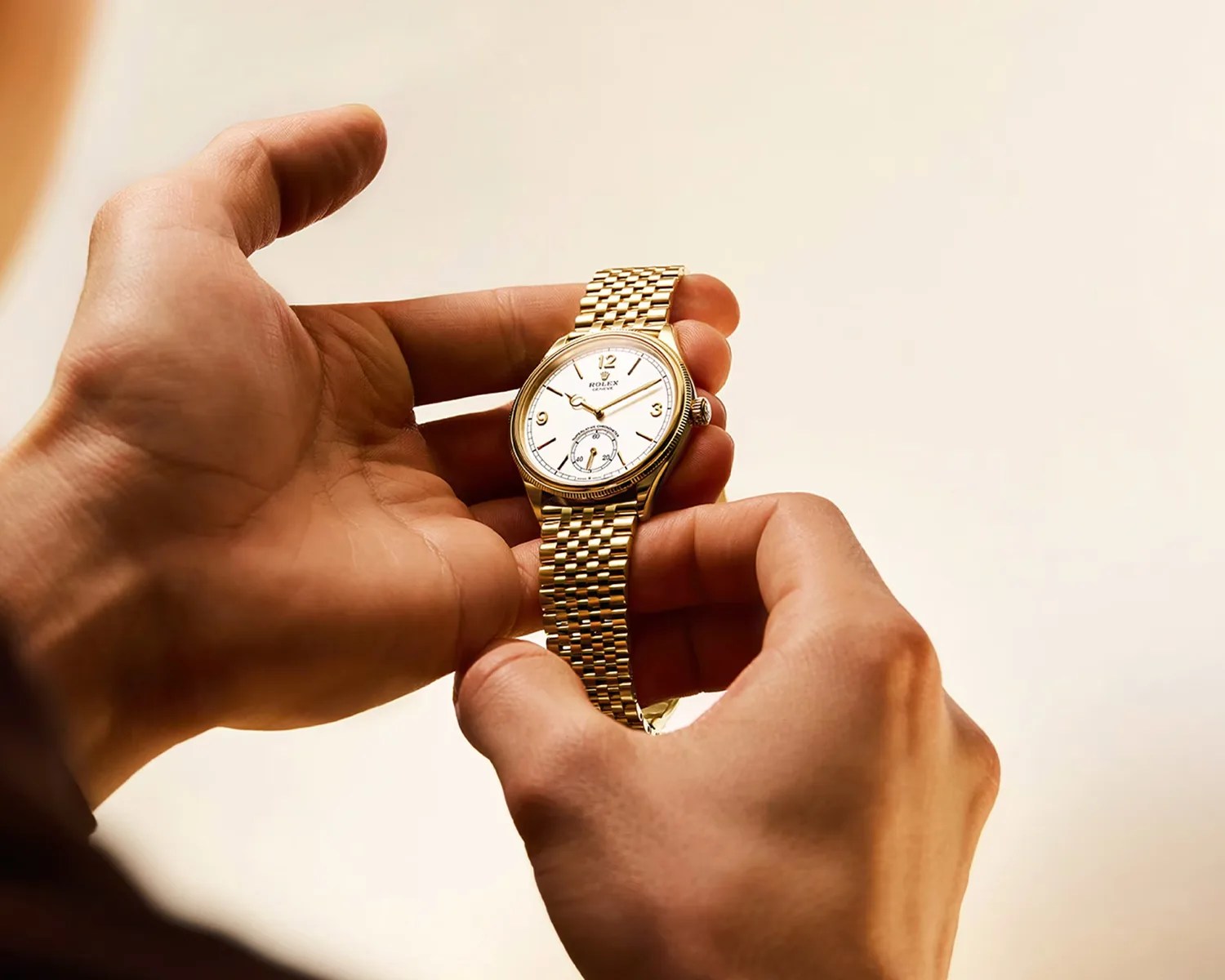 a person holding a rolex watch