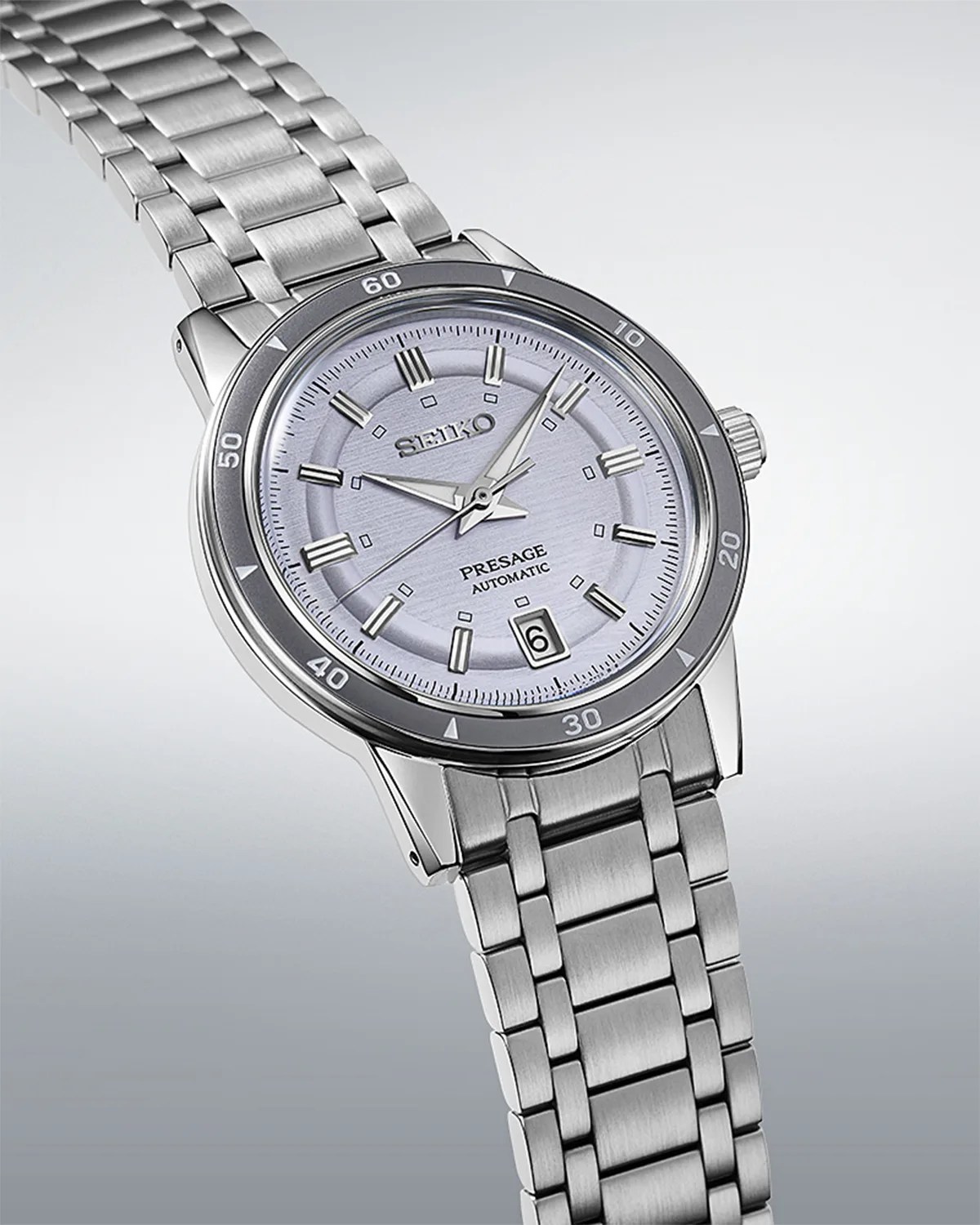 a Seiko watch with a purple dial and steel bracelet