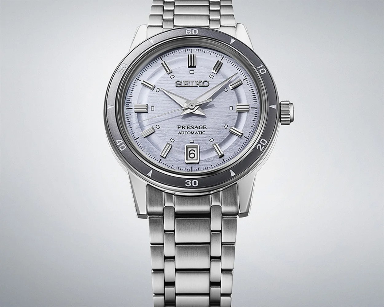 a Seiko watch with a steel bracelet and purple dial