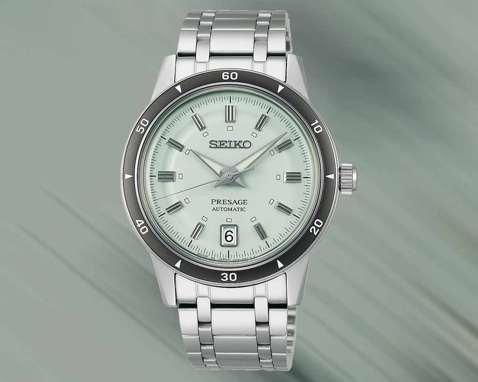 a Seiko watch with a green dial