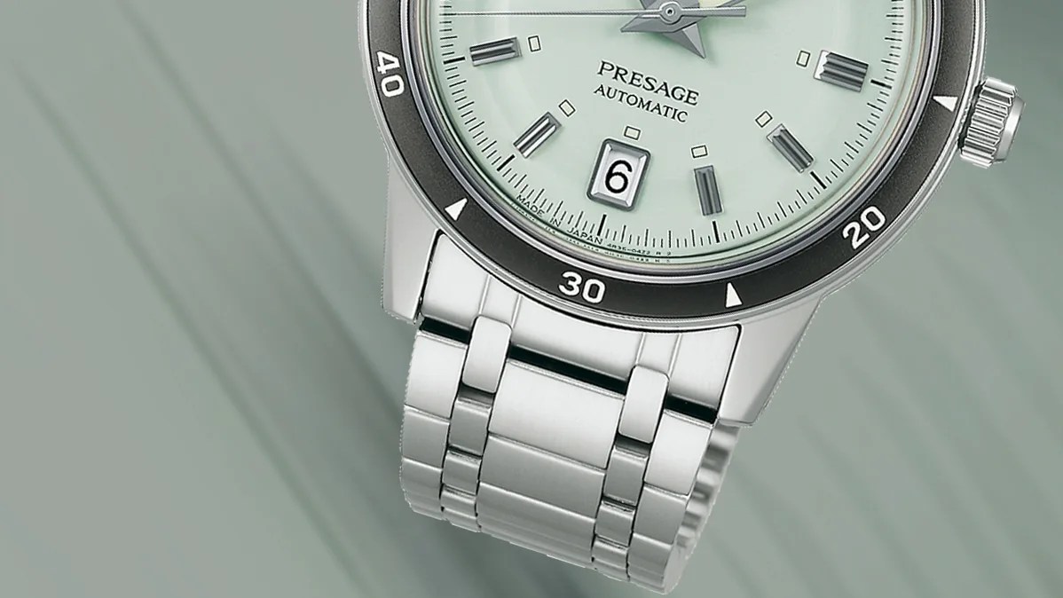 a Seiko watch with a green dial and steel bracelet