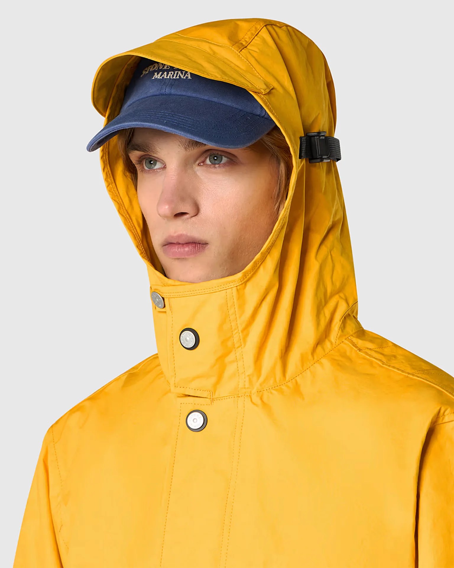 a man wearing a yellow raincoat with the hood up