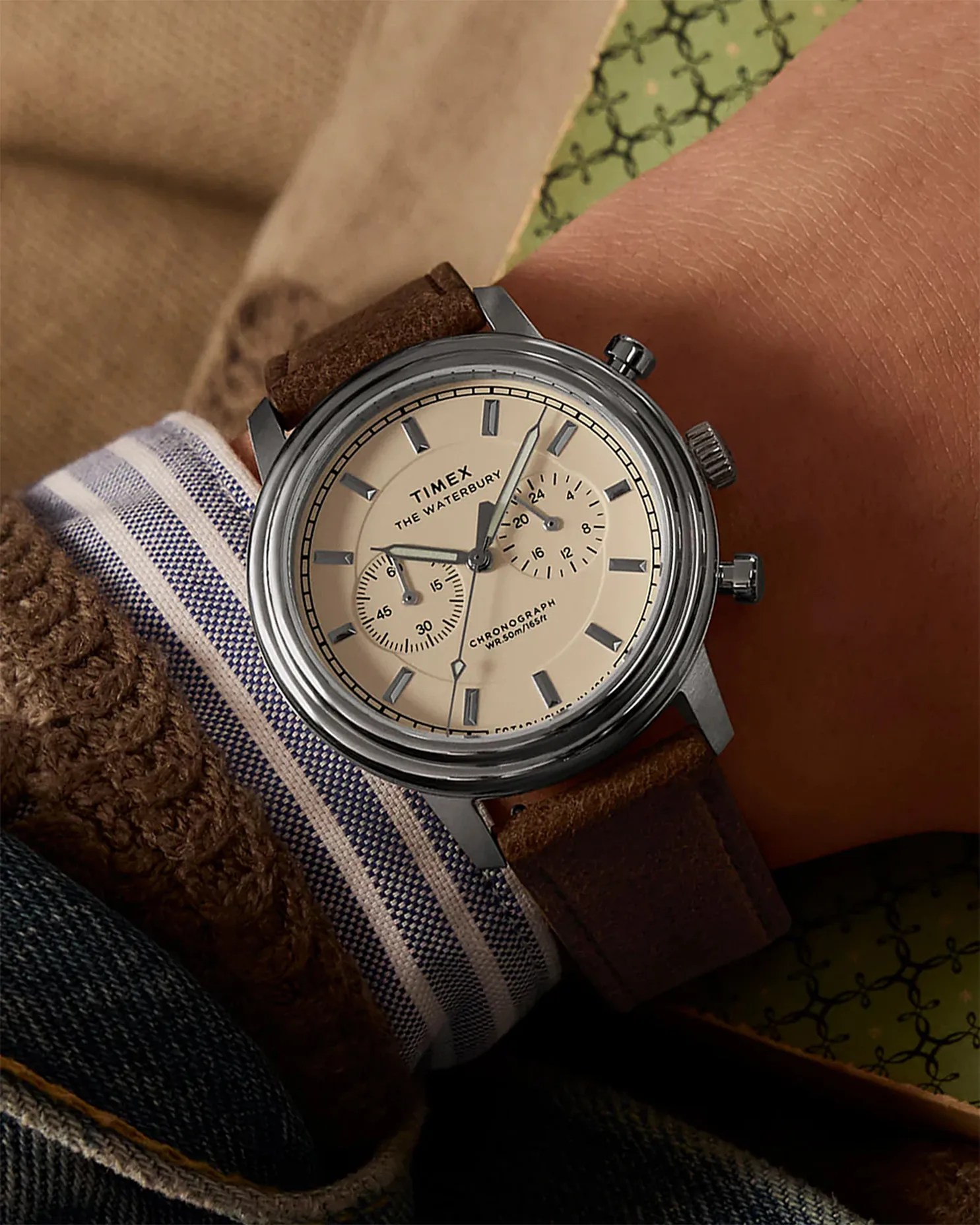 a white dial watch on a man's wrist