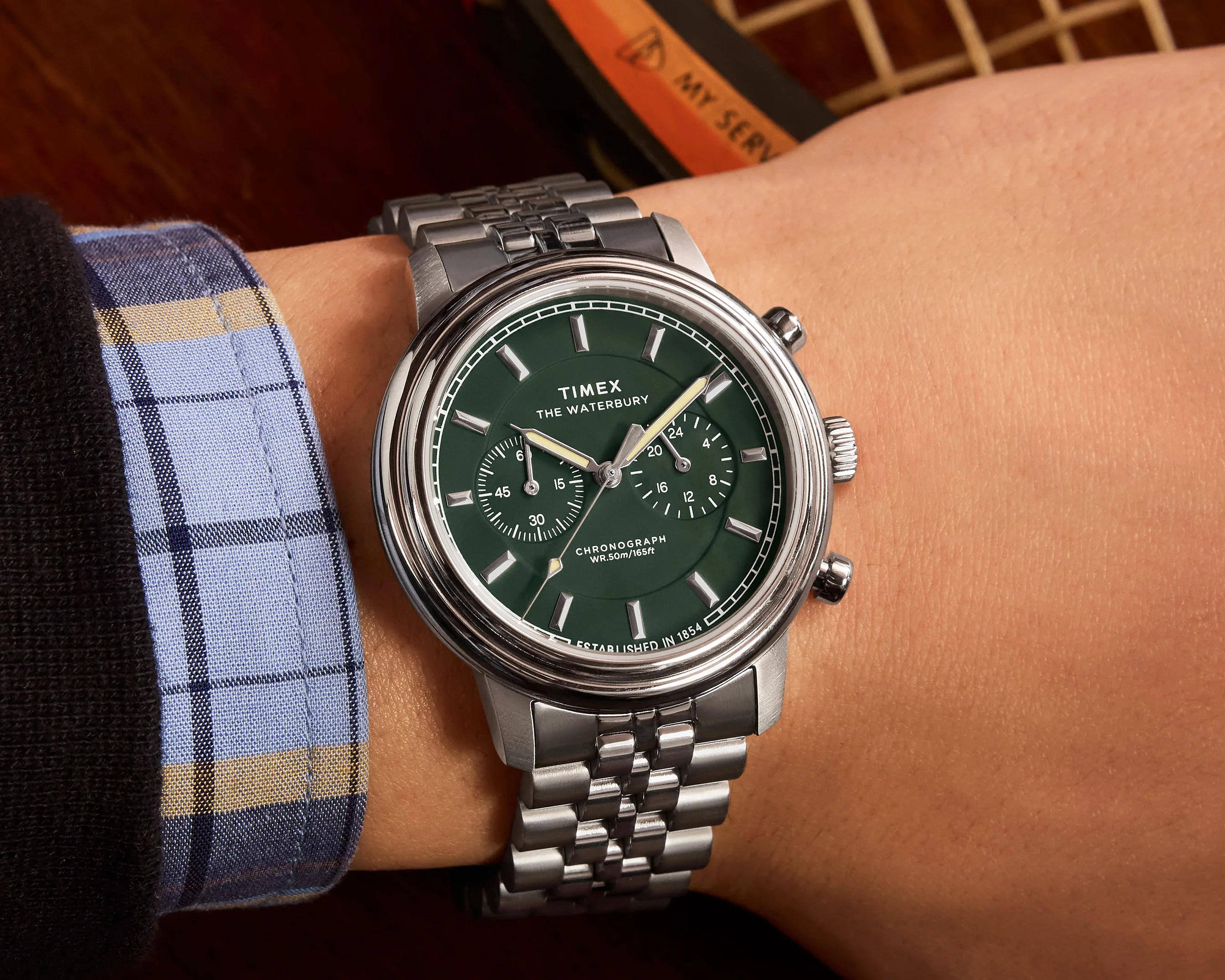 a green dial watch on a man's wrist