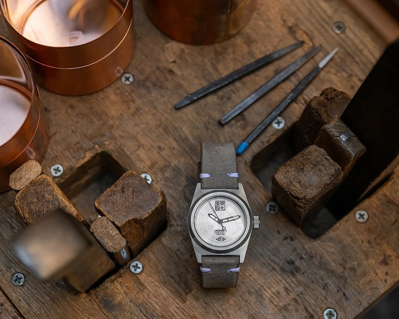a silver dial watch on a table