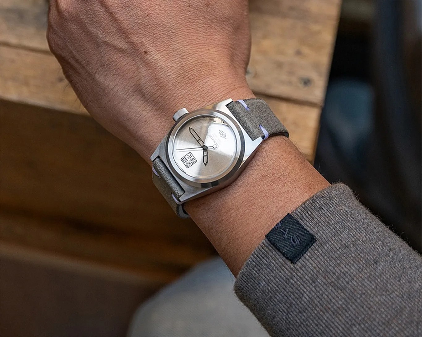 a silver dial watch on a man's wrist