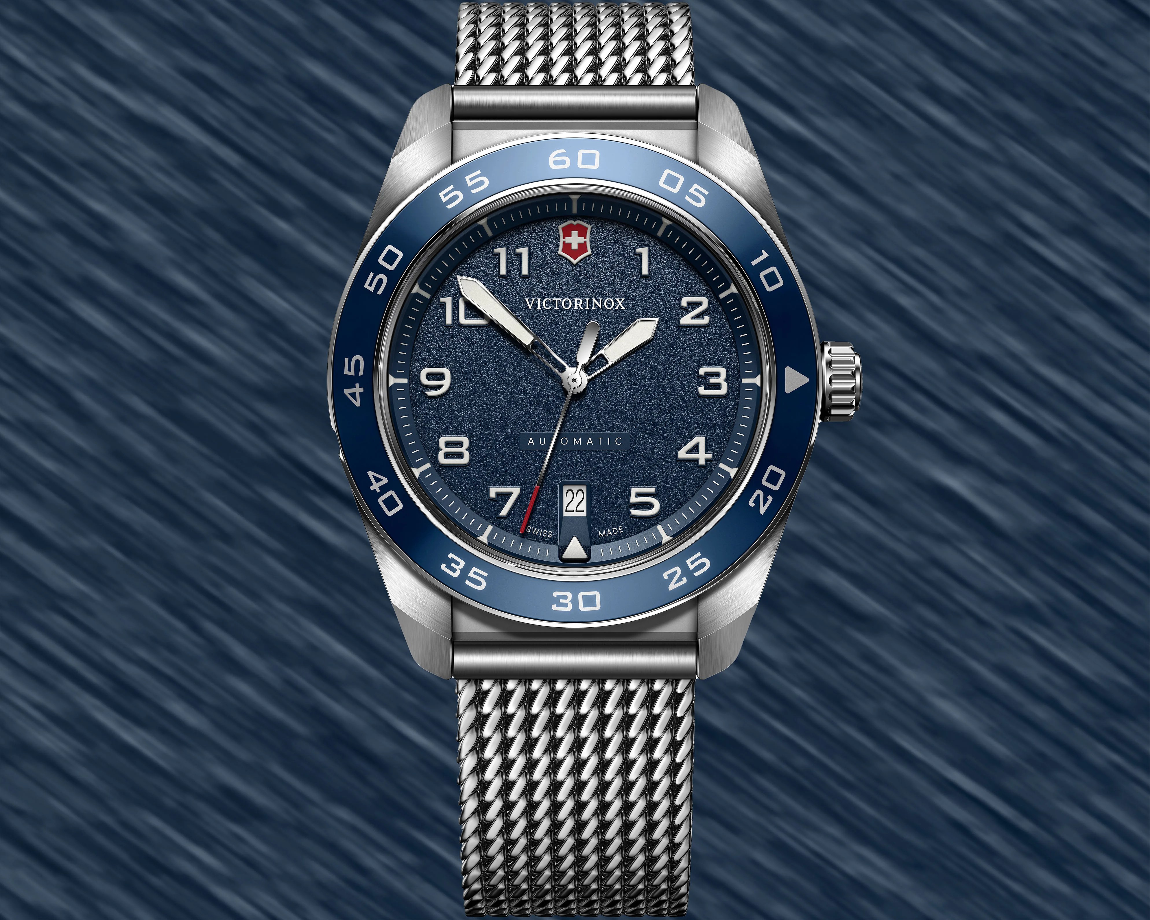 a Victorinox dive watch with a blue dial and steel mesh strap