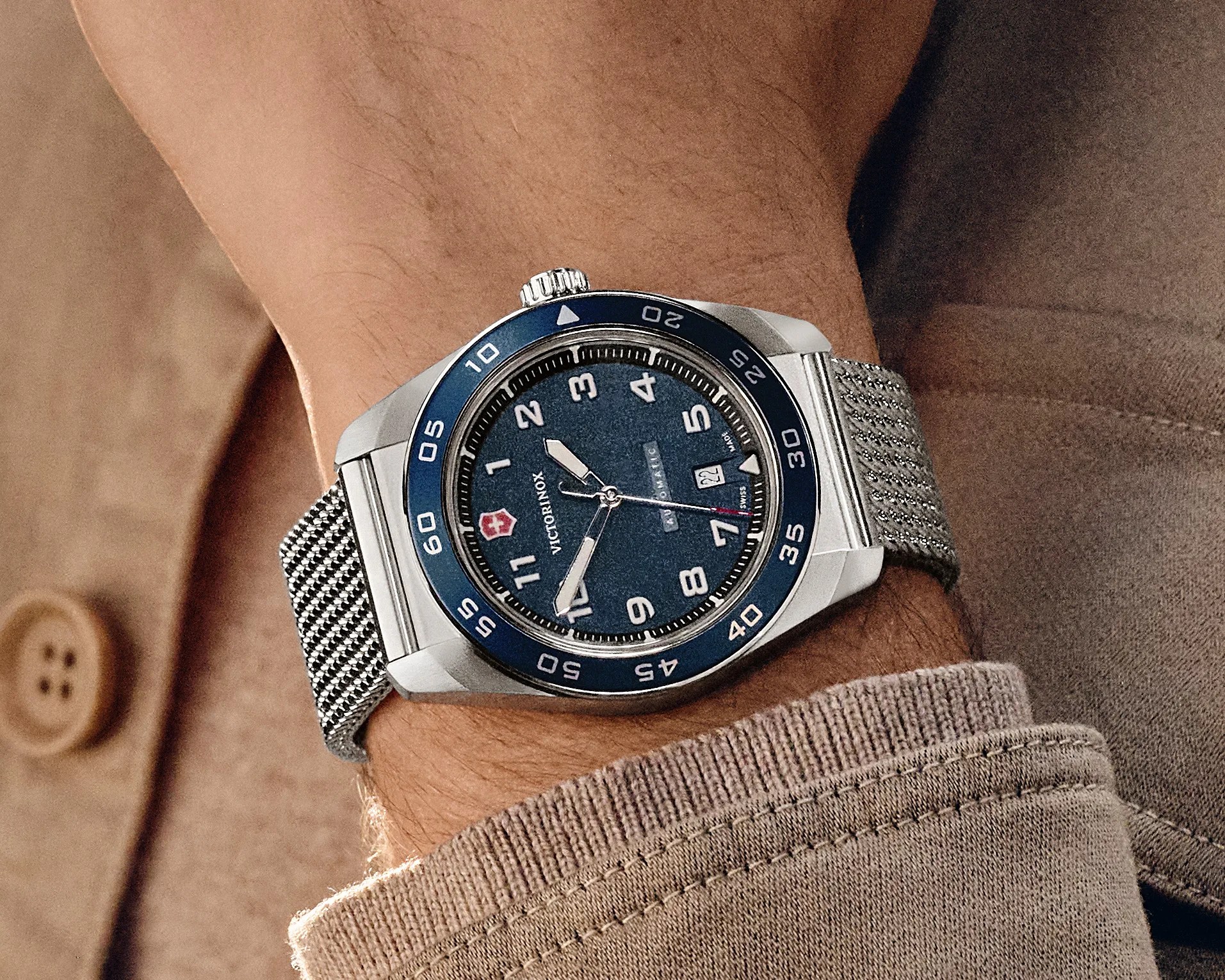 a blue dive watch on a man's wrist
