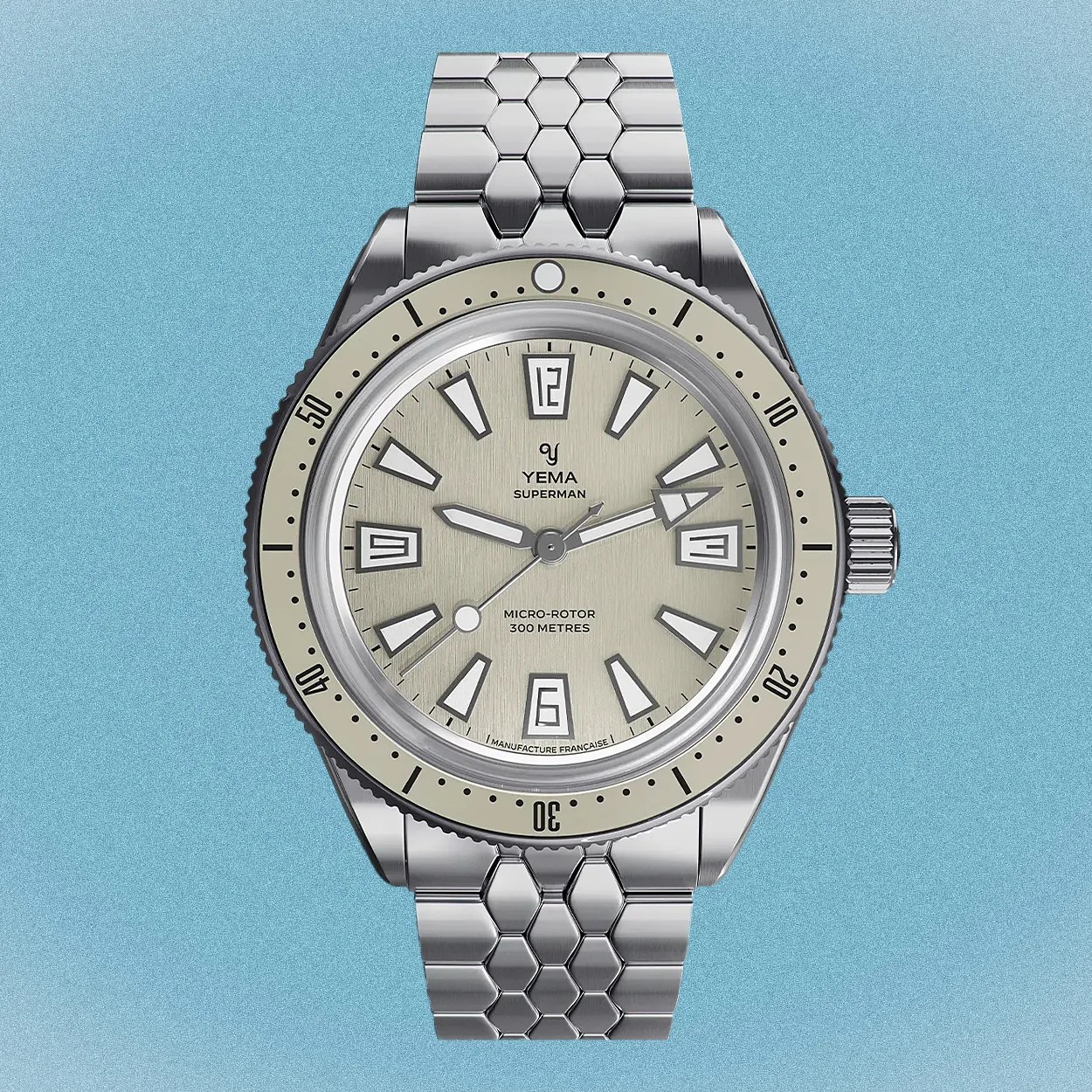 a steel Yema dive watch with a tan dial