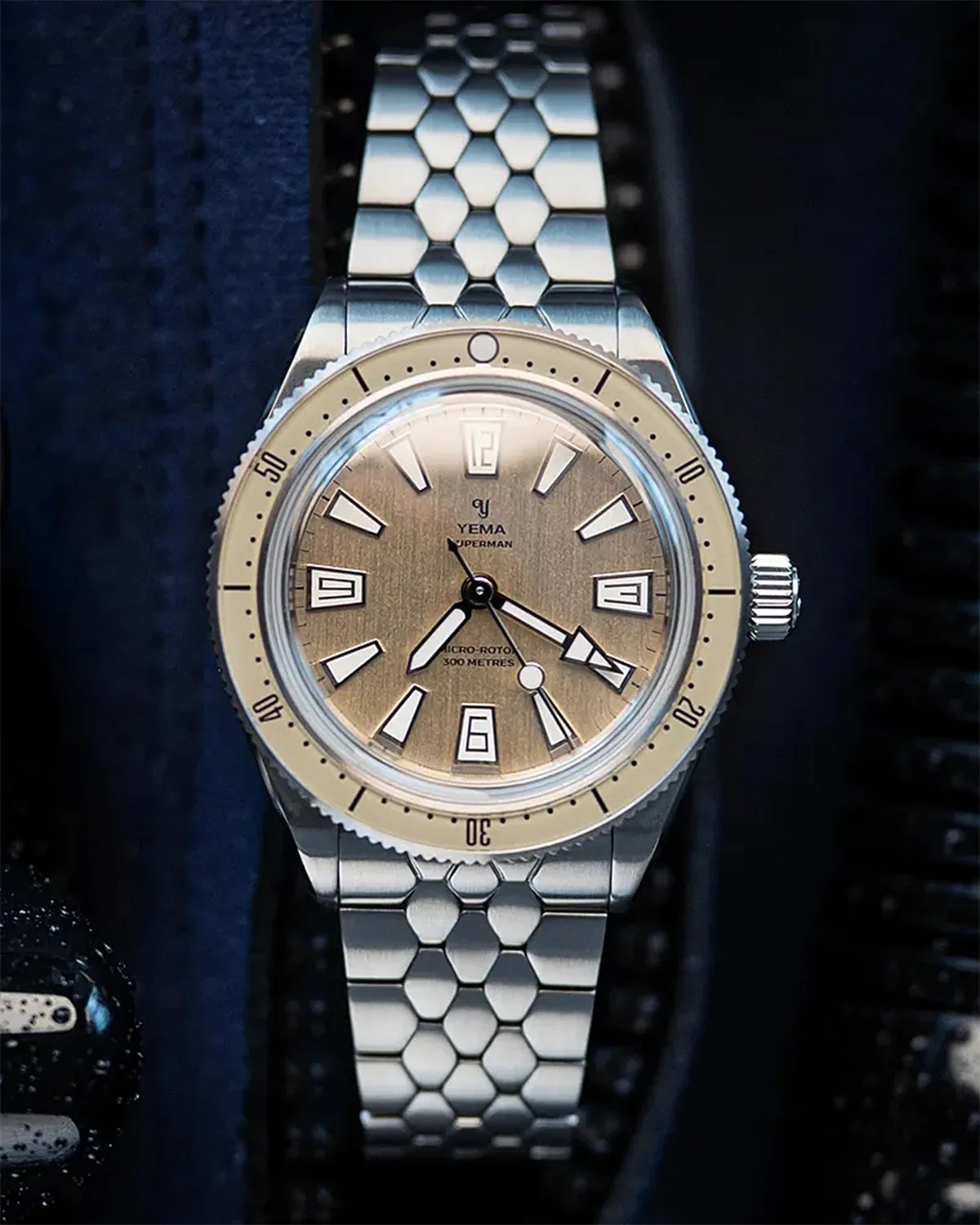 a Yema dive watch with a tan dial