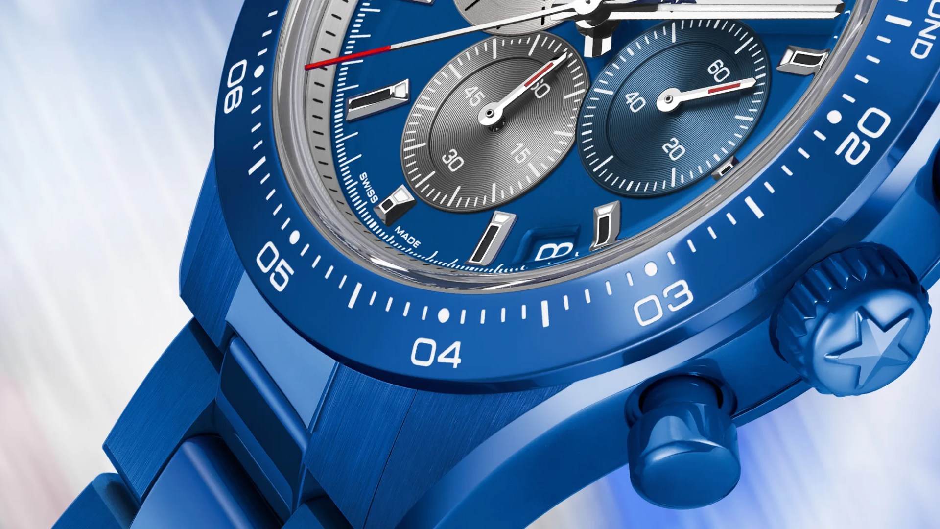 the dial, bezel and crown of a blue Zenith chronograph watch