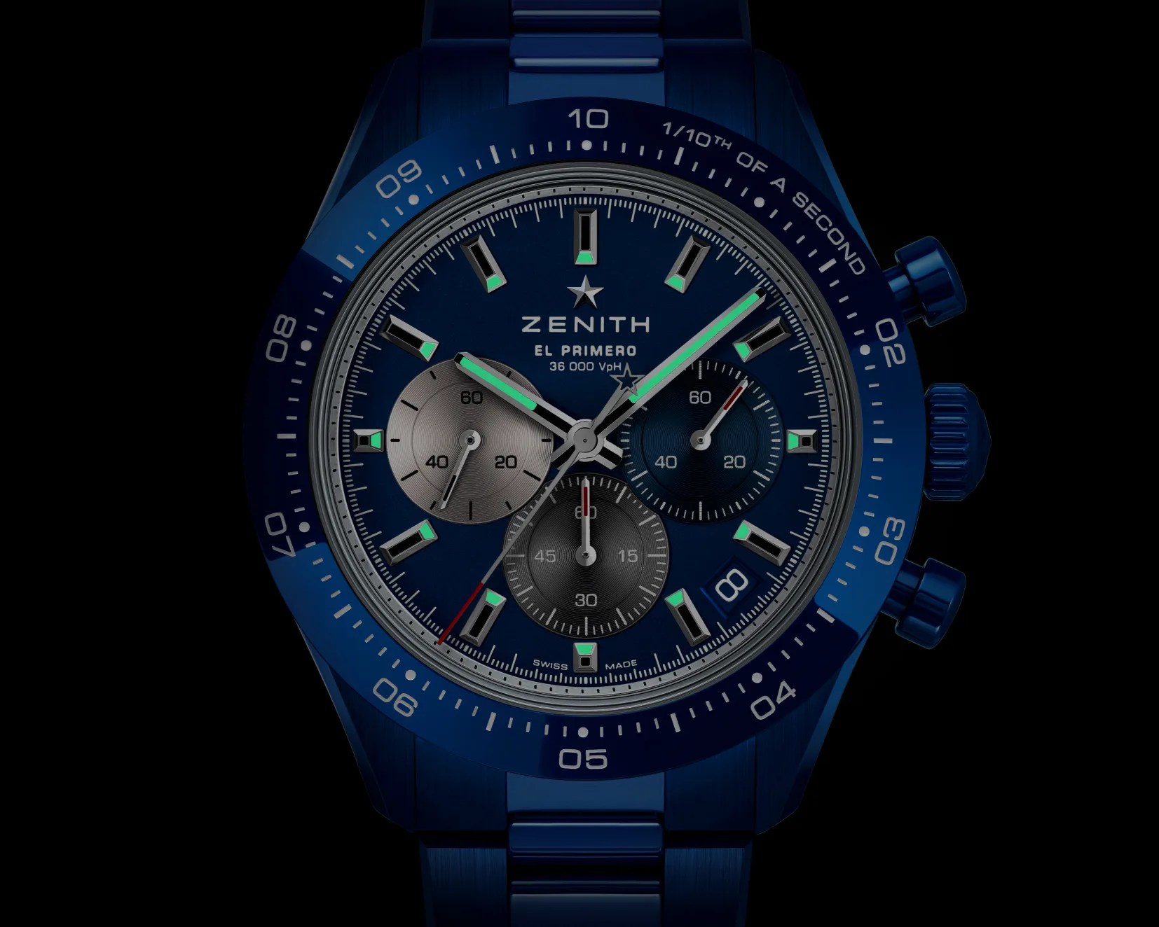 a chronograph watch in the dark with the lume showing