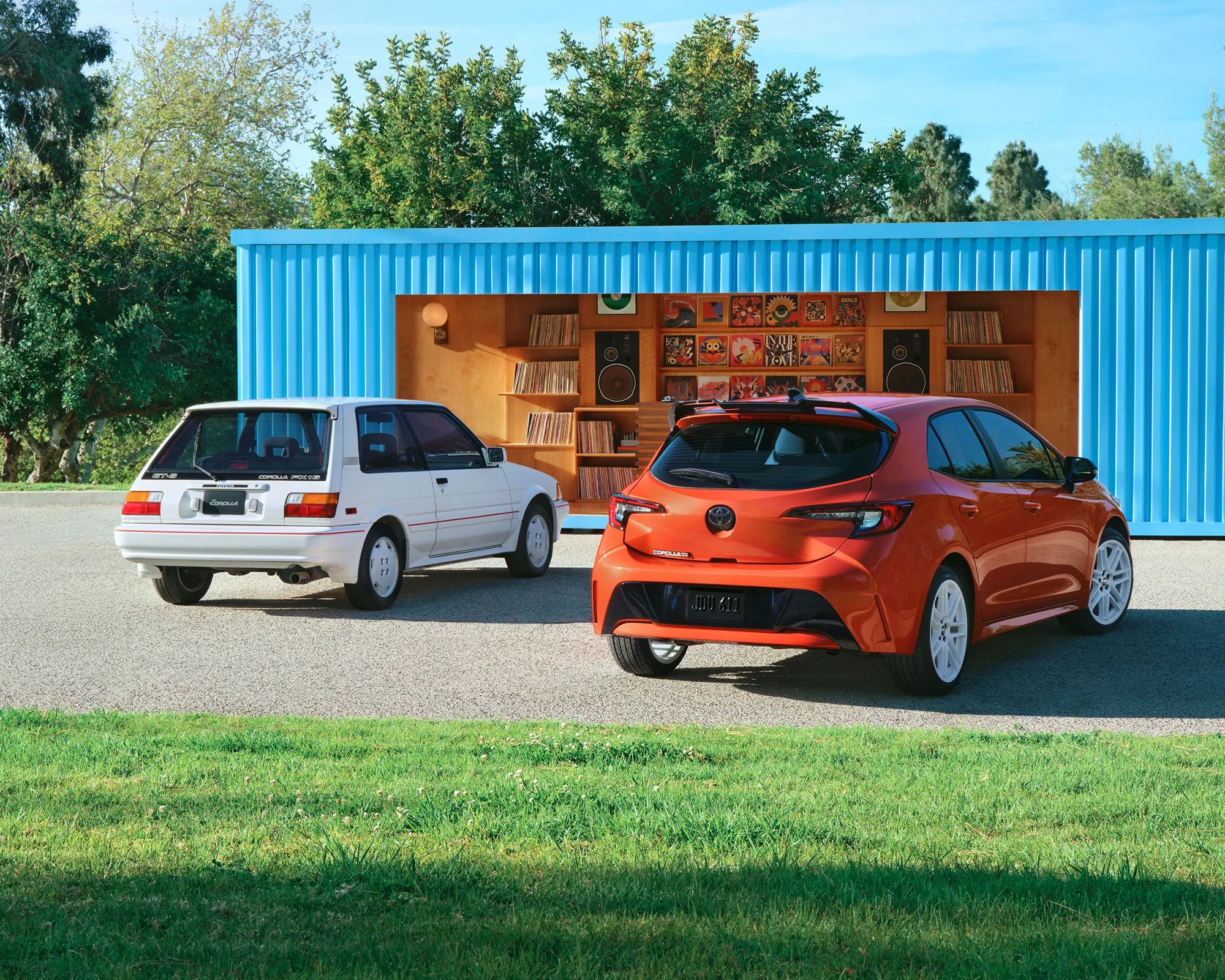 2026 Toyota Corolla Hatchback FX Edition next to old Corolla in front of record store
