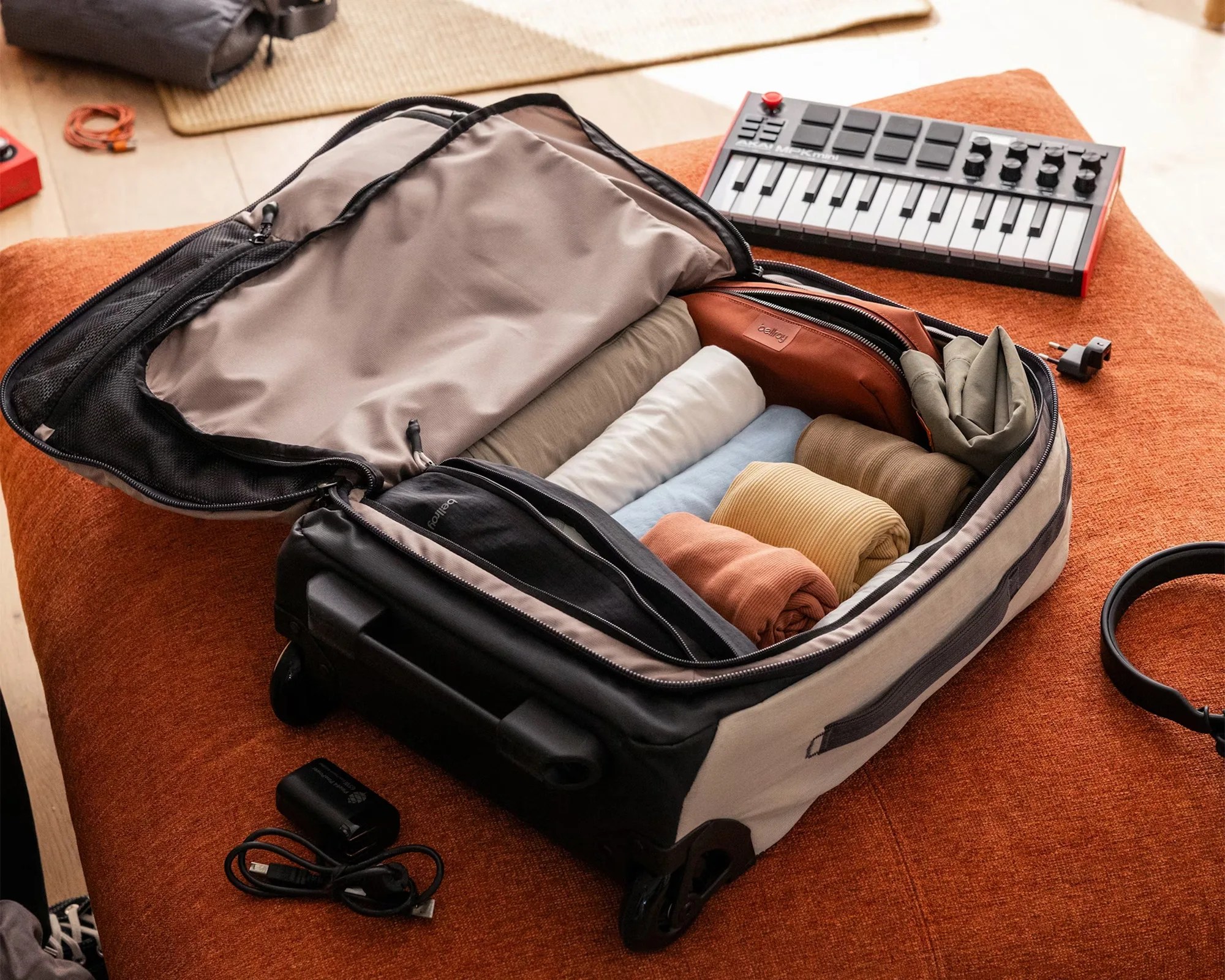 Bellroy Lite carry-on open on bed with equipment around it