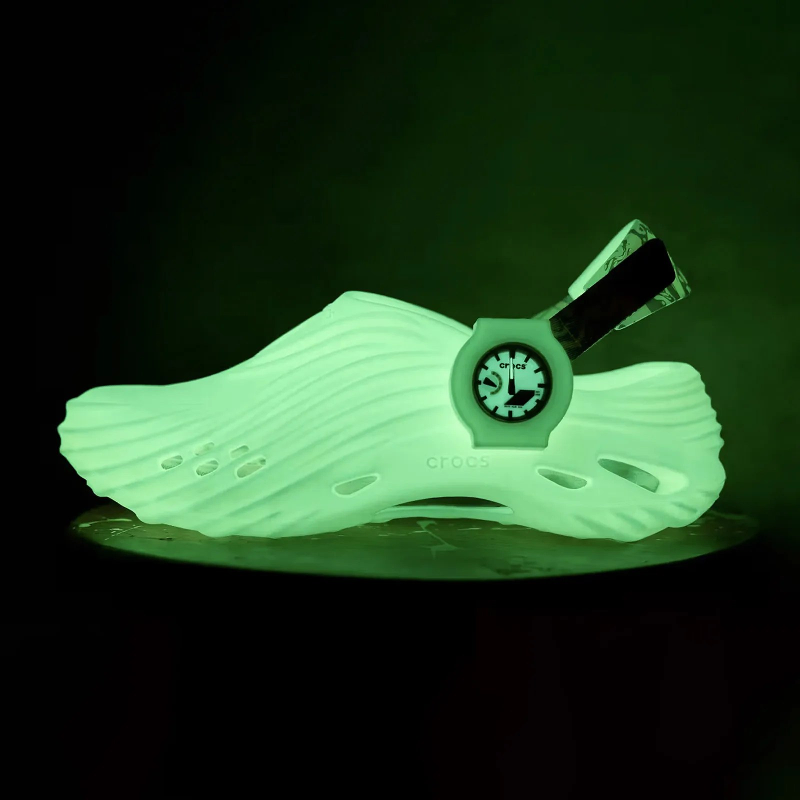 The G-Shock x Crocs Echo Wave shoe shown glowing in the dark