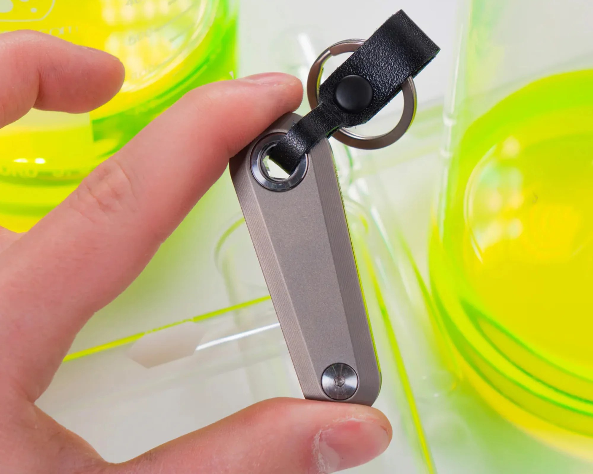 Flytanium Minim Keychain Folder knife in hand in laboratory