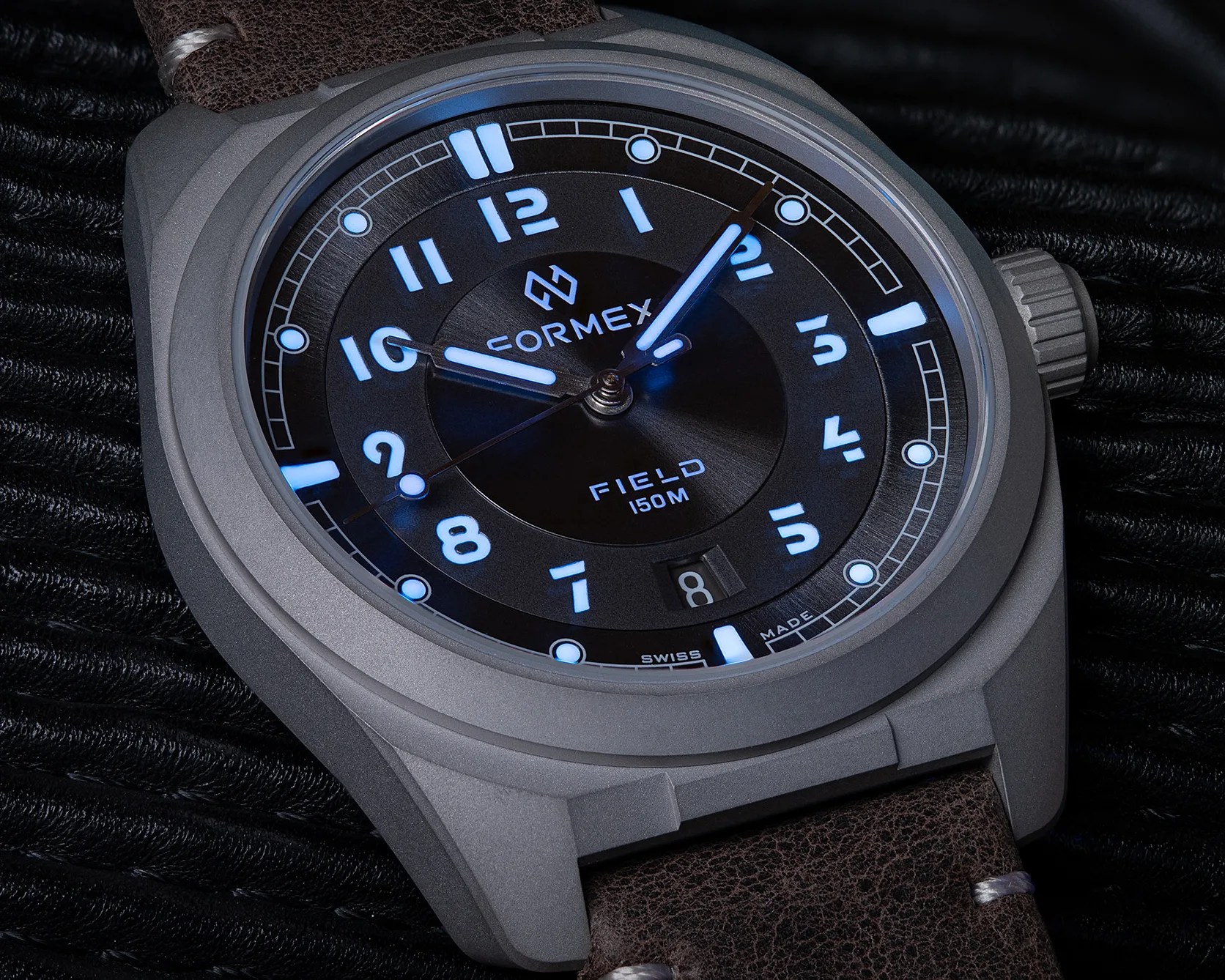 a Formex field watch in the dark with dial lume glowing