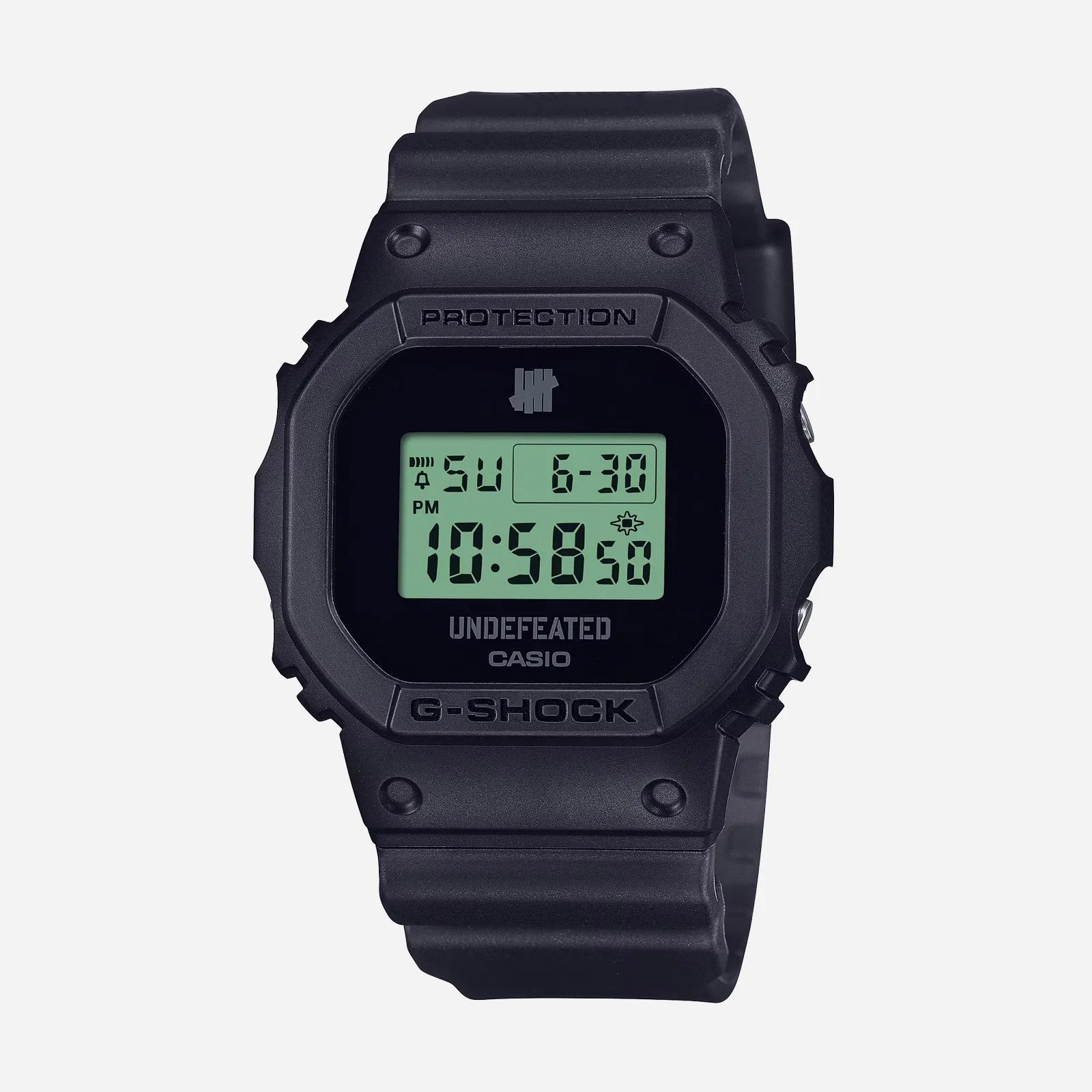The G-Shock and 'Undefeated' DWE5600UD with a black strap shown against a light grey background. 
