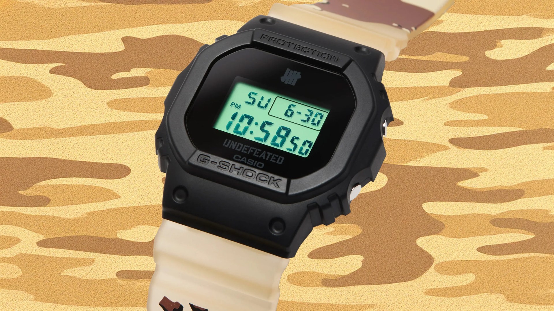 A close-up of the G-Shock and 'Undefeated' DWE5600UD with a light camo strap