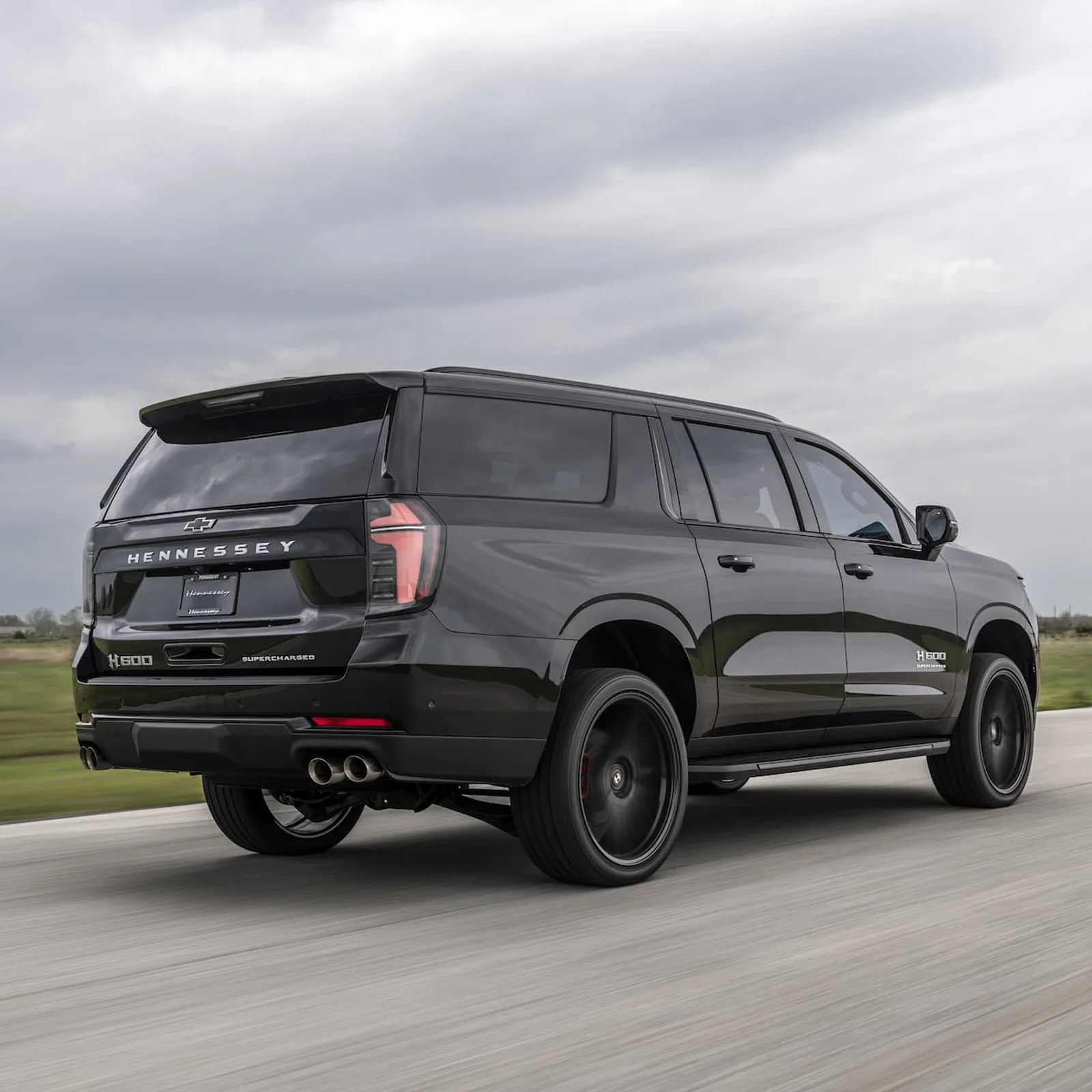 An angled view of the 2025 Chevy Suburban H 600 Hennessey Performance driving on a track