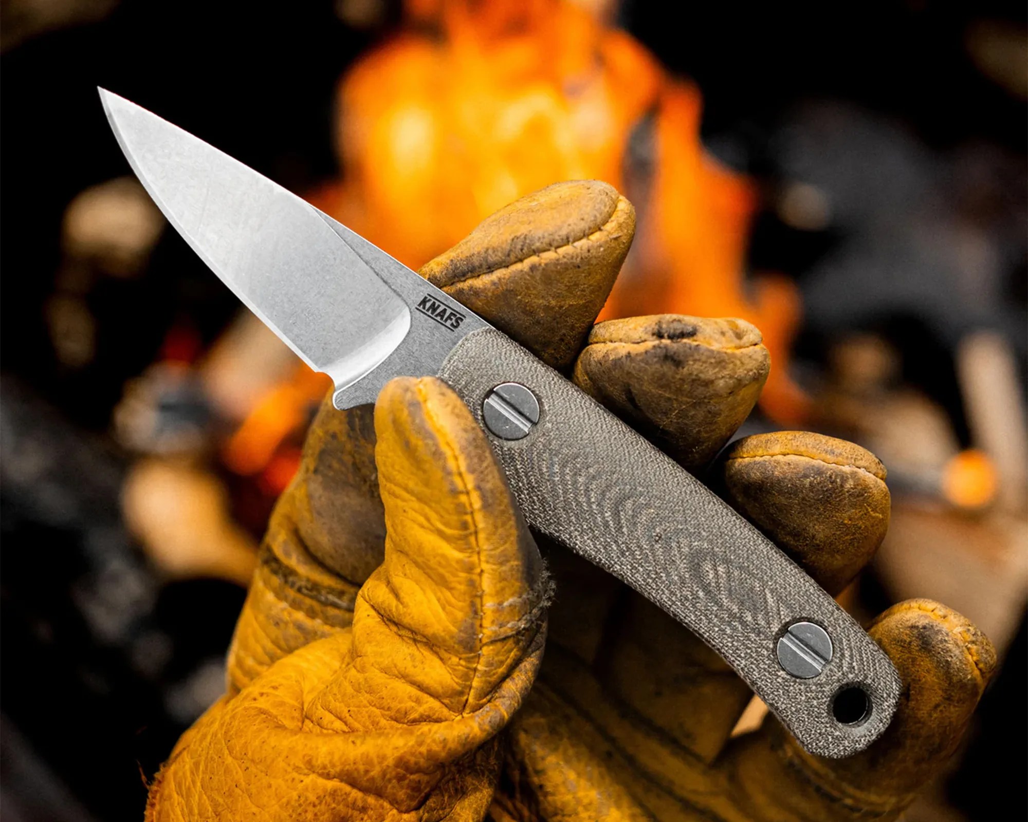 Knafs Little Lulu Knife in gloved hand in front of fire