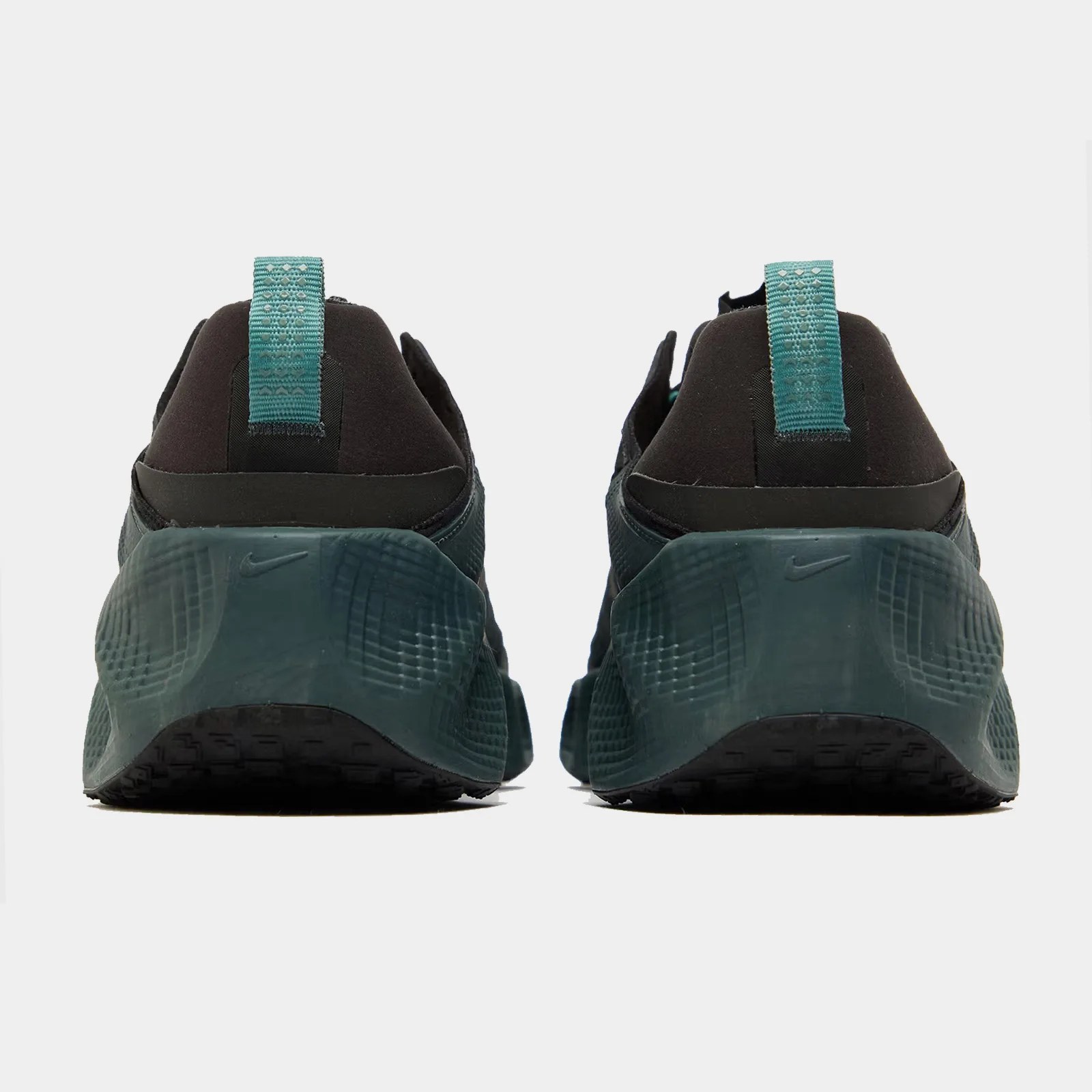 A Nike AVA Rover sneaker from the heels in dark green and black
