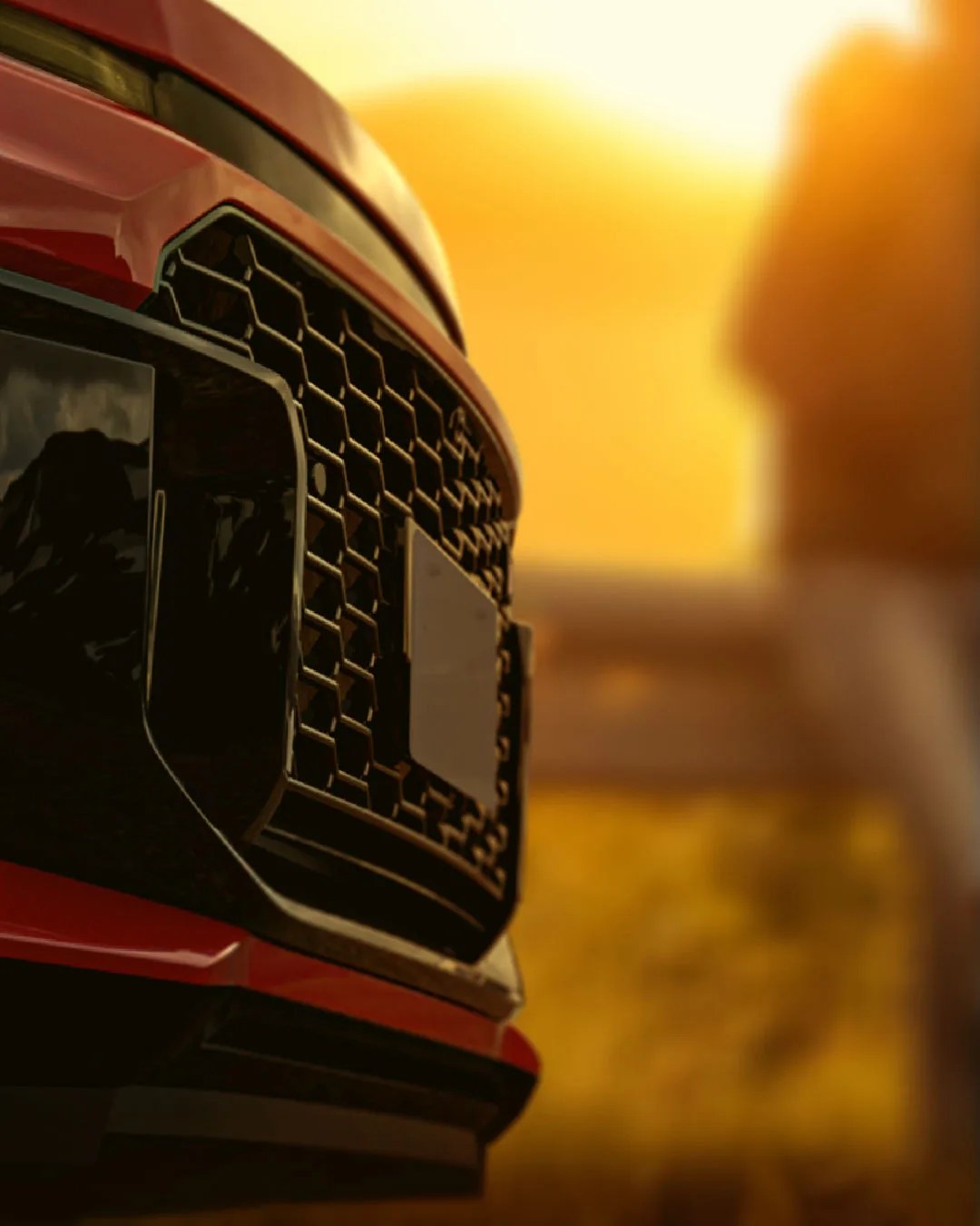 A close-up of the 2026 Toyota RAV4 grill in black and red