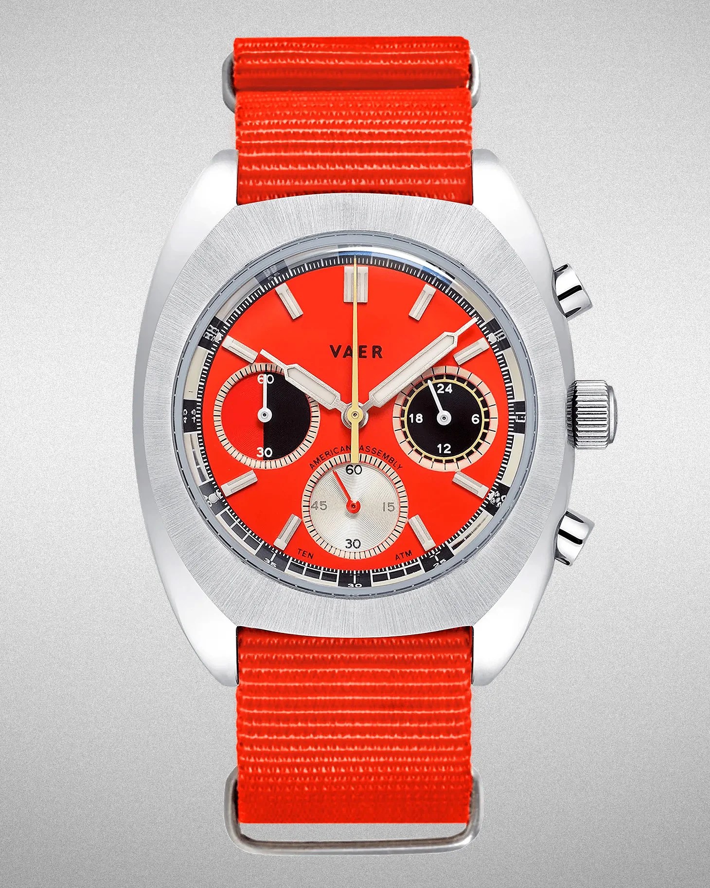 a Vaer watch with an orange nato strap