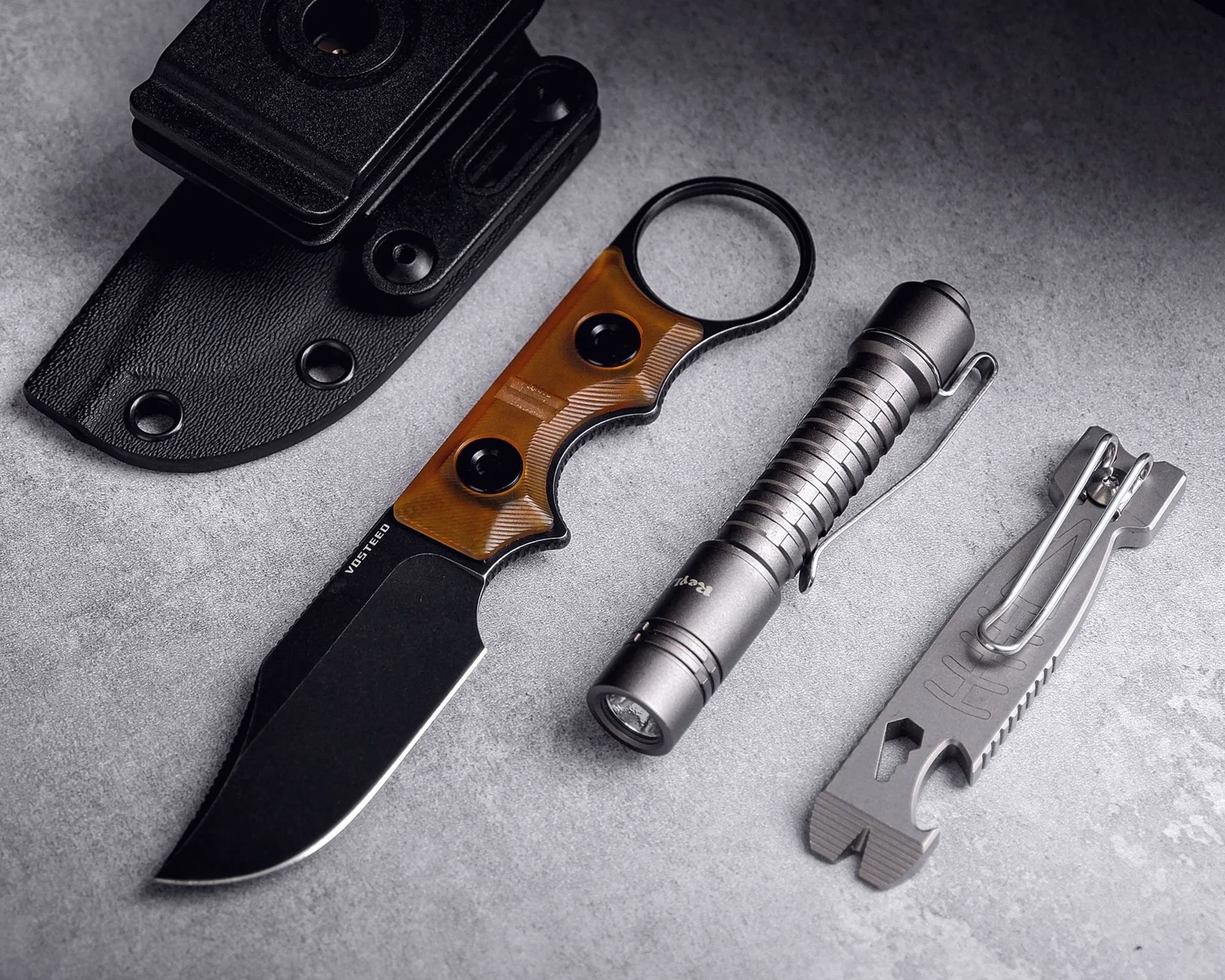 Vosteed Quokka Bowie Knife next to flashlight, sheath and multi-tool