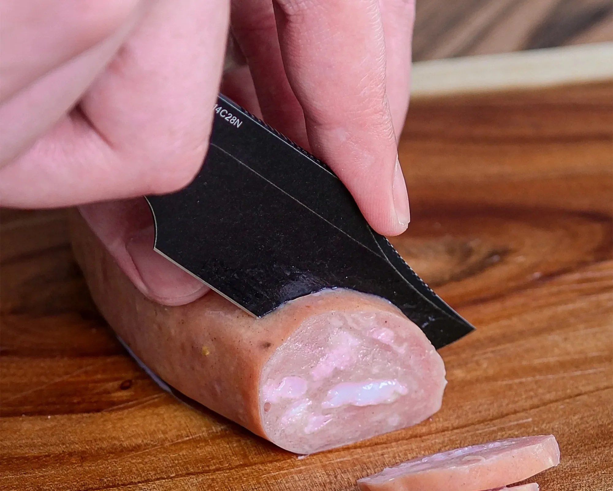 Vosteed Quokka Bowie Knife closeup cutting cured meat