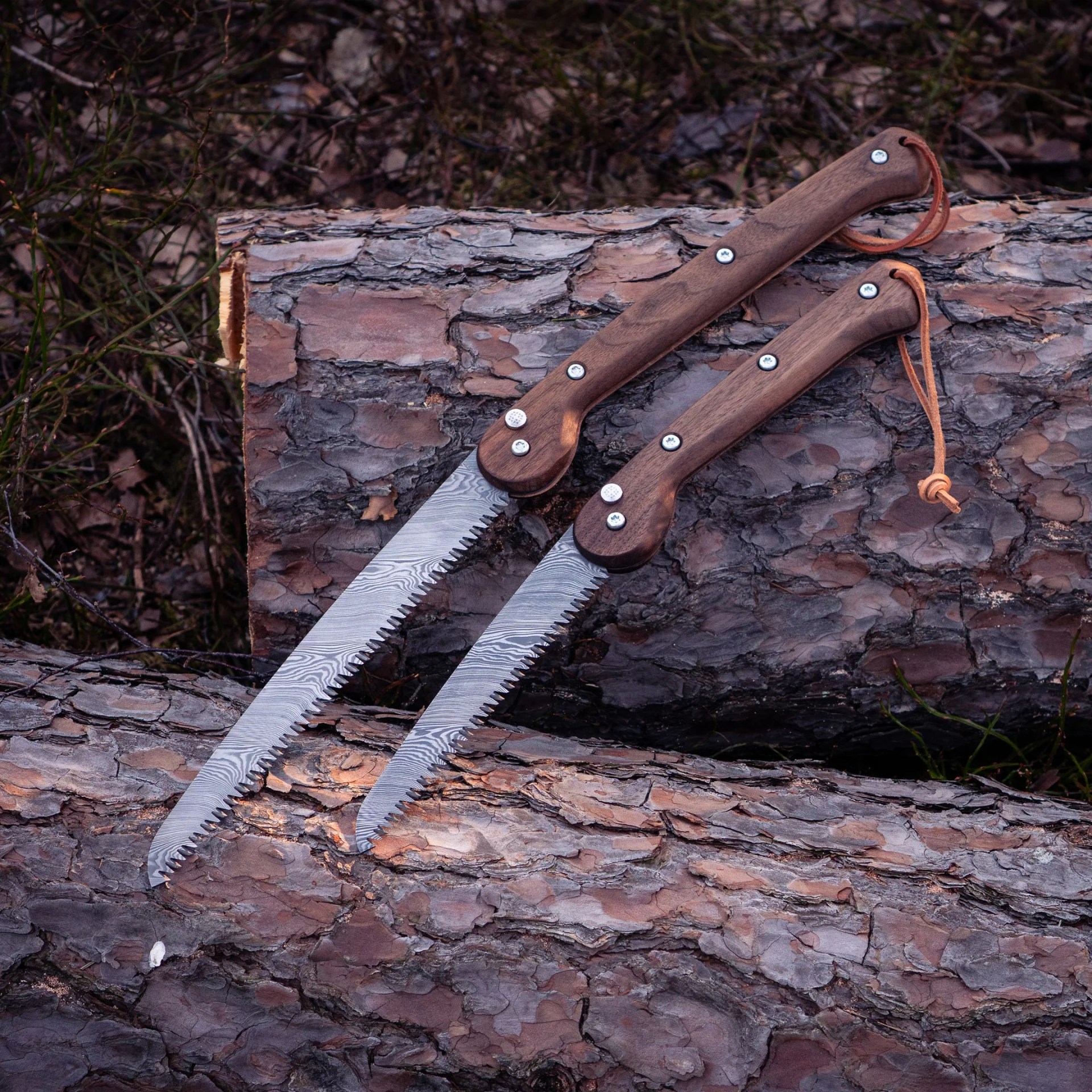 Woxna Damascus Steel Folding Saws on wood