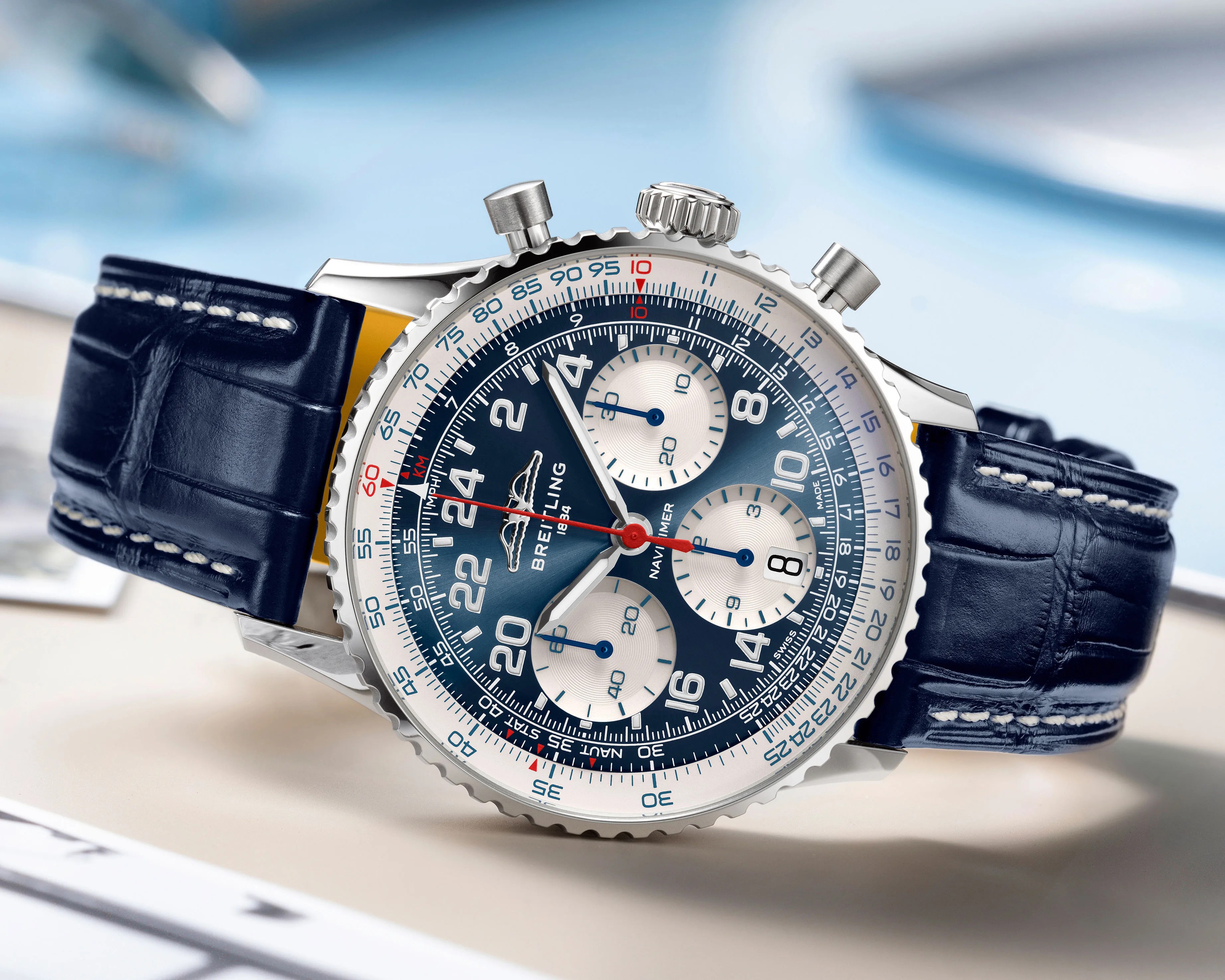 a Breitling watch with a blue dial and strap