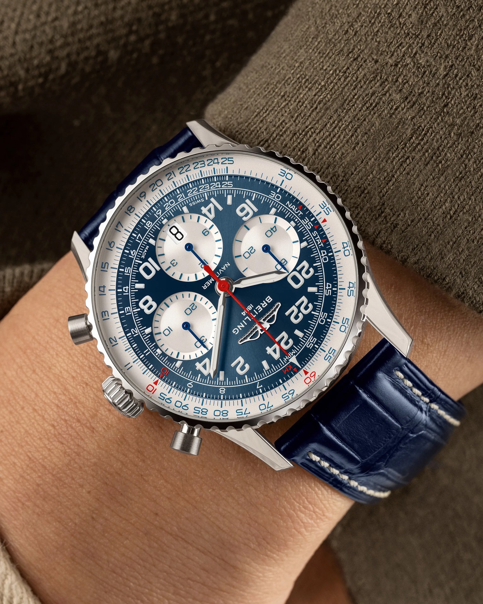 a blue Breitling chronograph watch