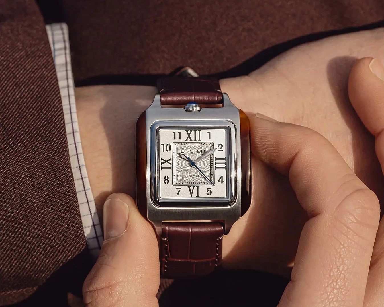 a square Brtiston dress watch on a man's wrist
