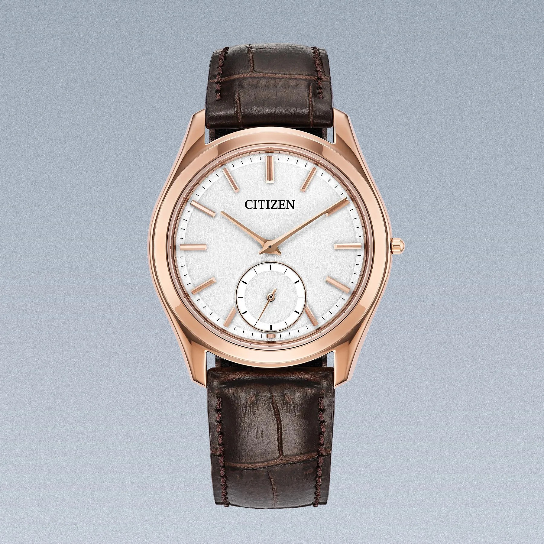 a gold Citizen dress watch with a brown leather strap