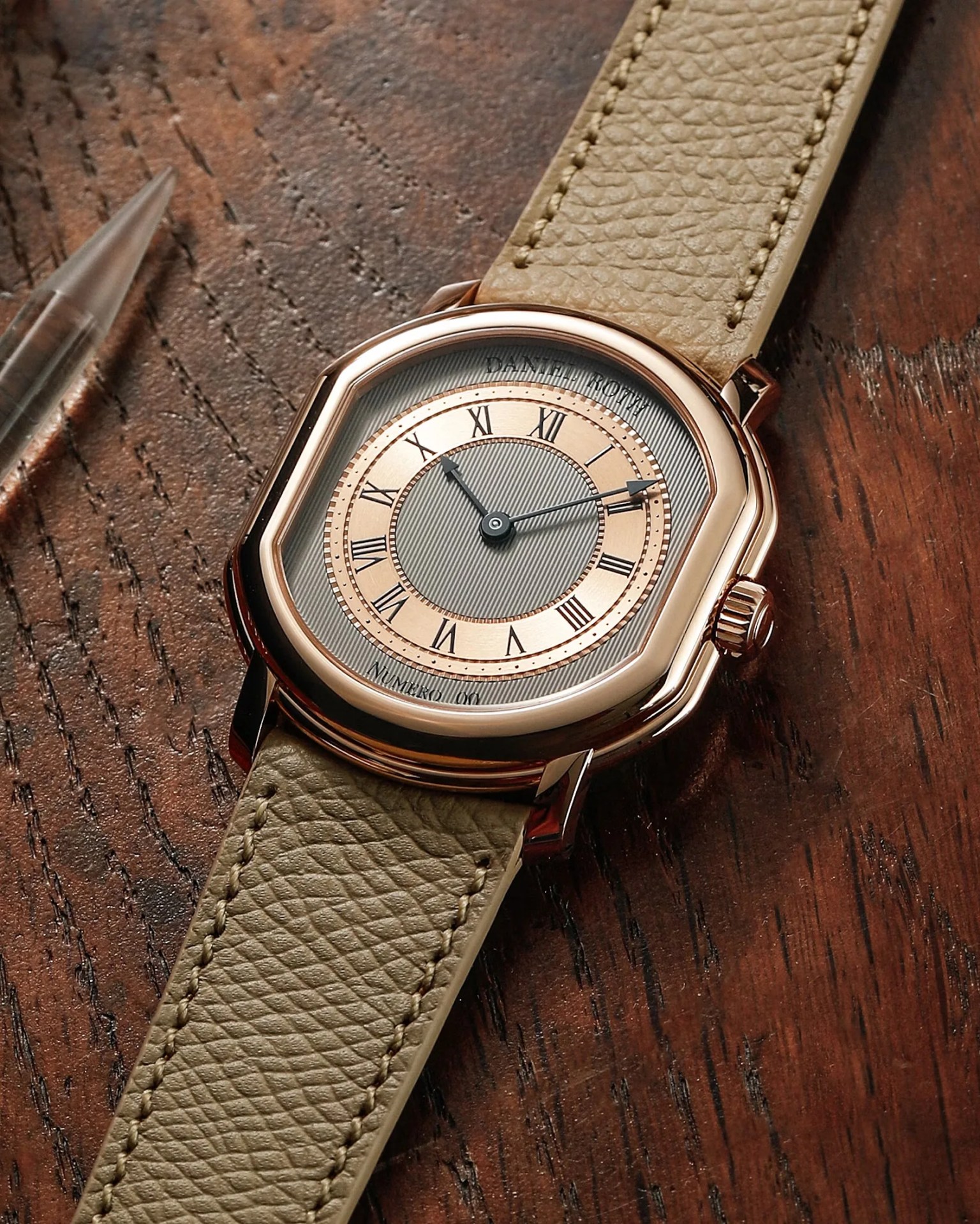 a gold dress watch lying on a table