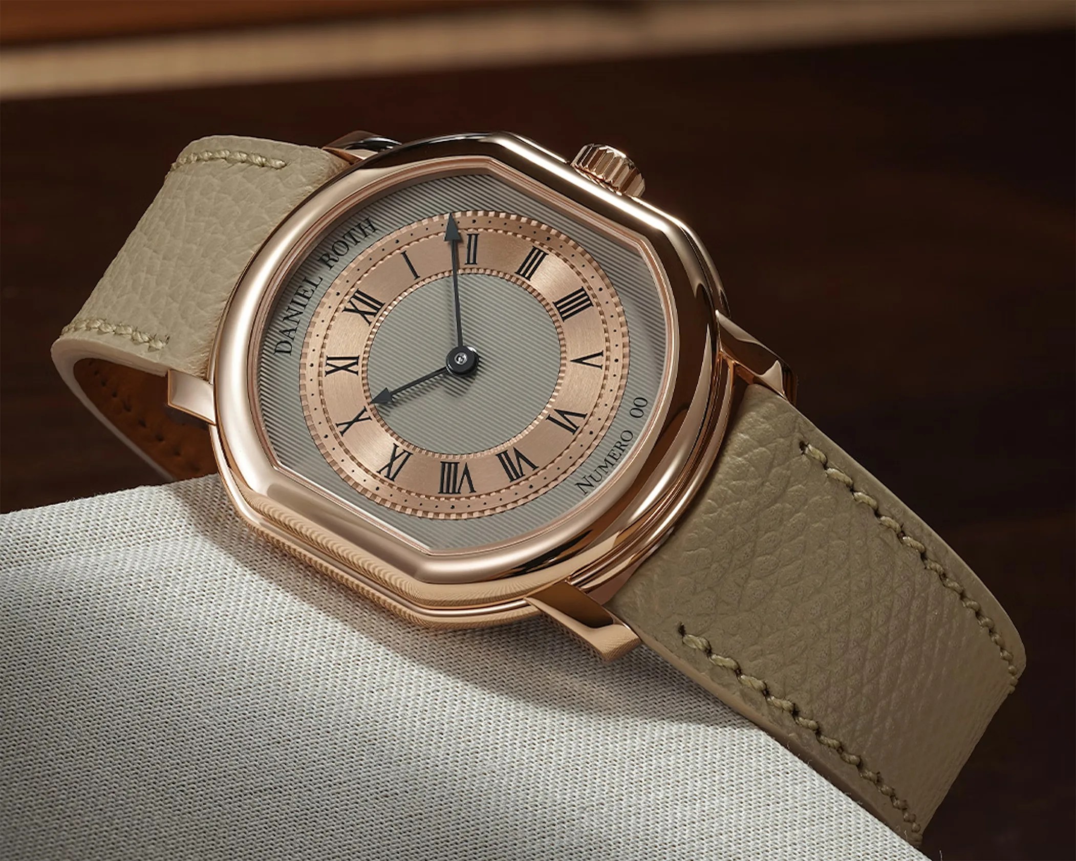 a gold dress watch lying on a table