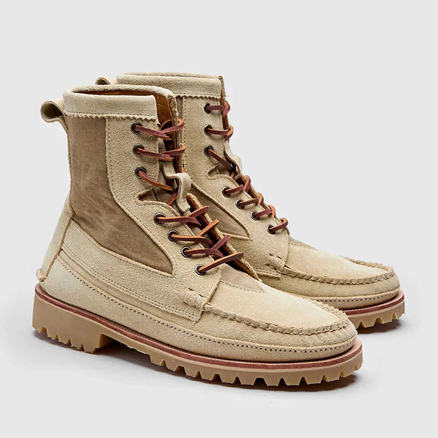 a pair of suede moc toe boots