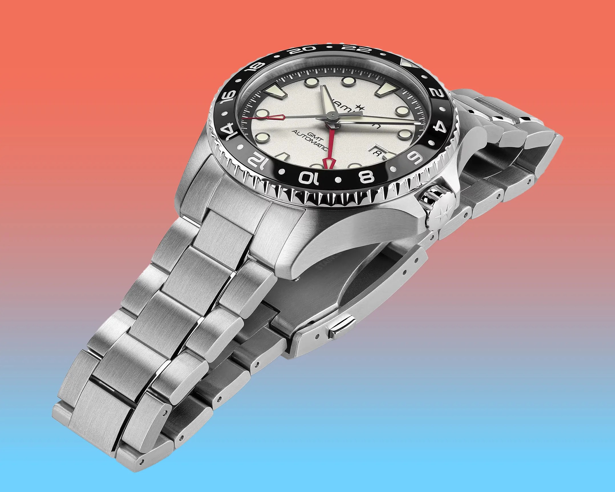 a steel Hamilton dive watch with a white dial