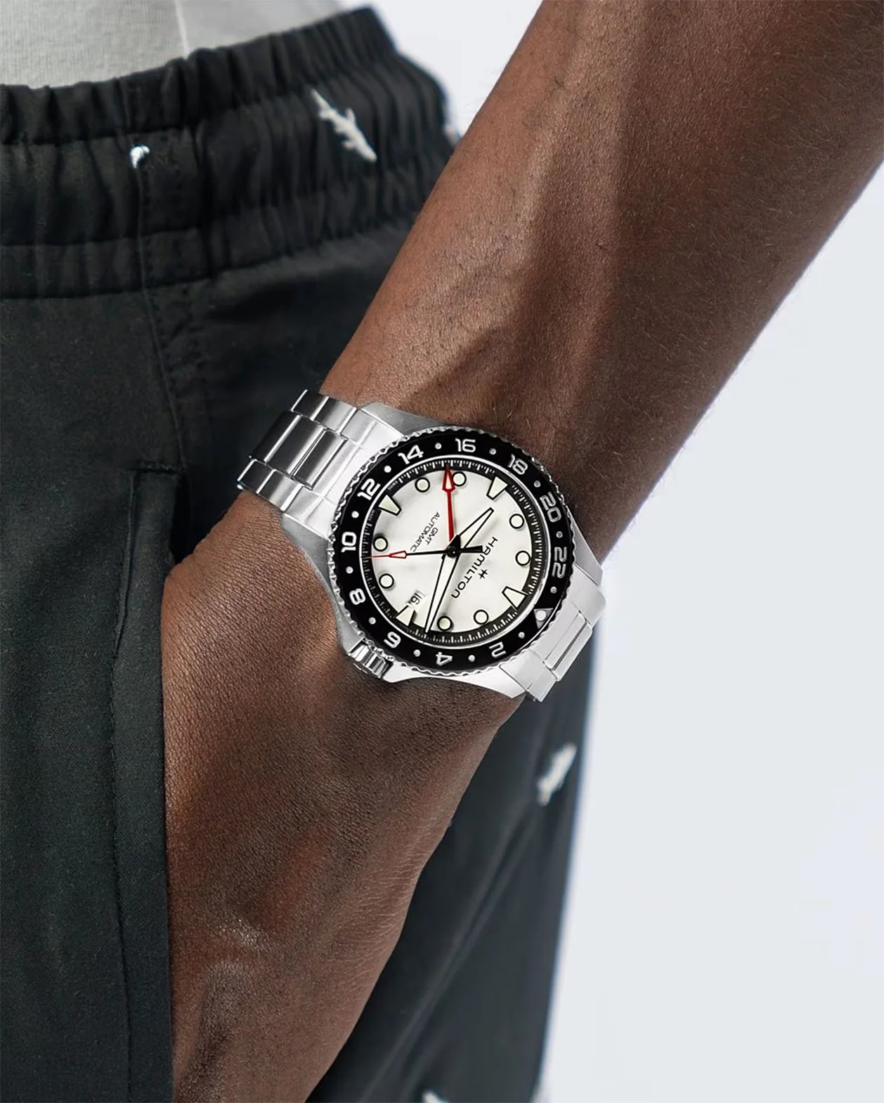 a steel dive watch on a man's wrist