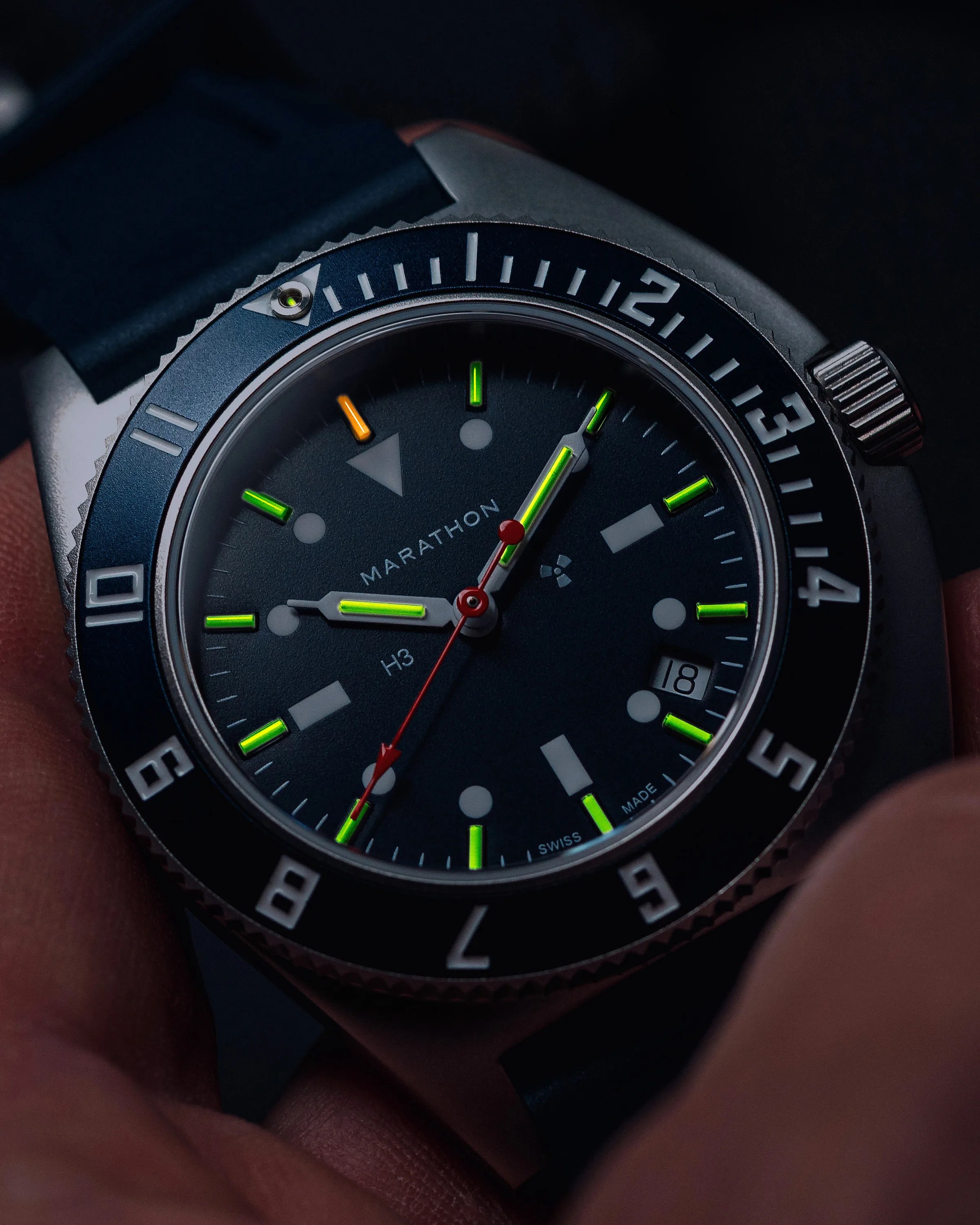 a Marathon dive watch in the dark with lume glowing