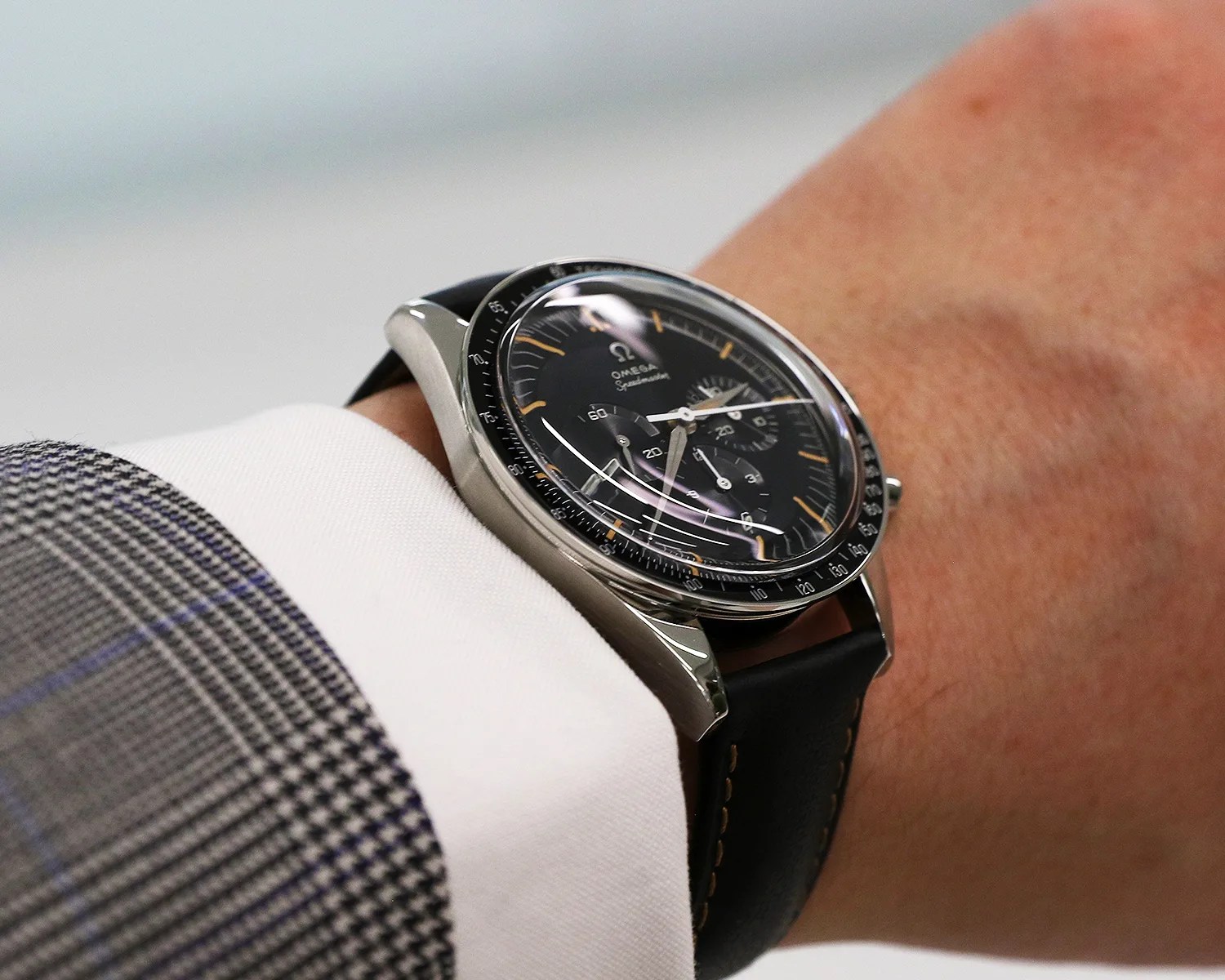 an omega watch on a mans wrist