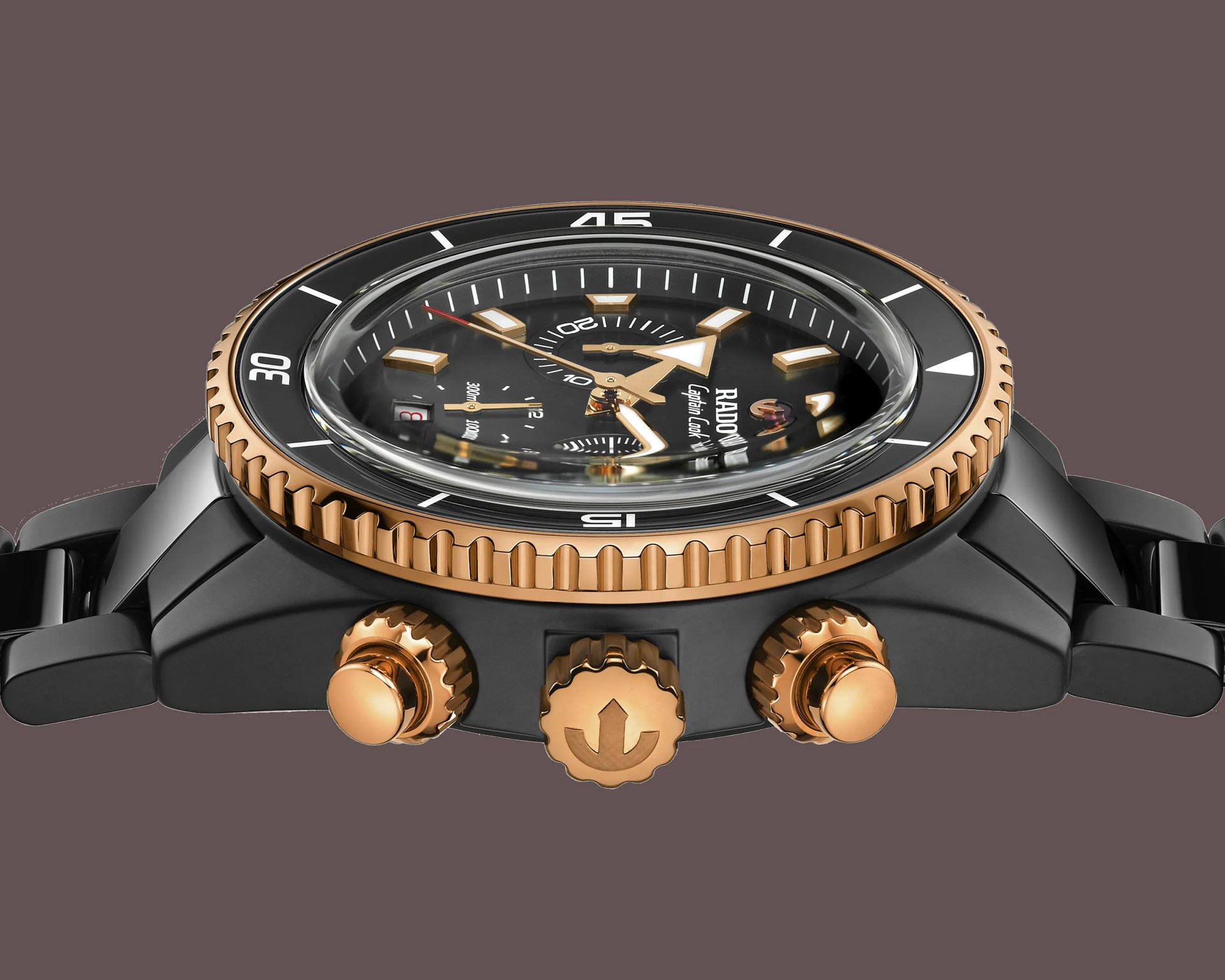 the side of a black and gold Rado watch