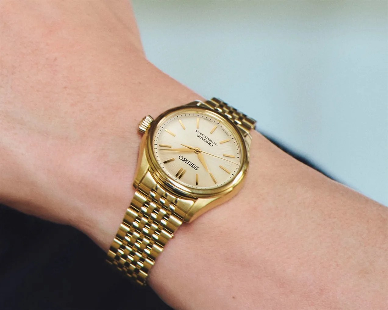 a gold watch on a man's wrist