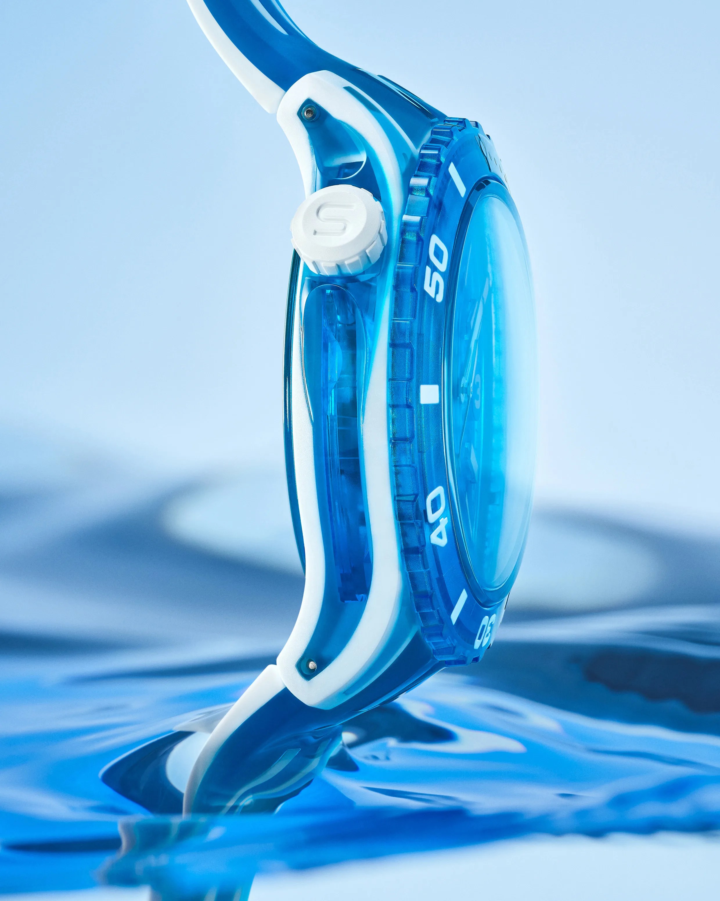a blue Swatch dive watch in the water