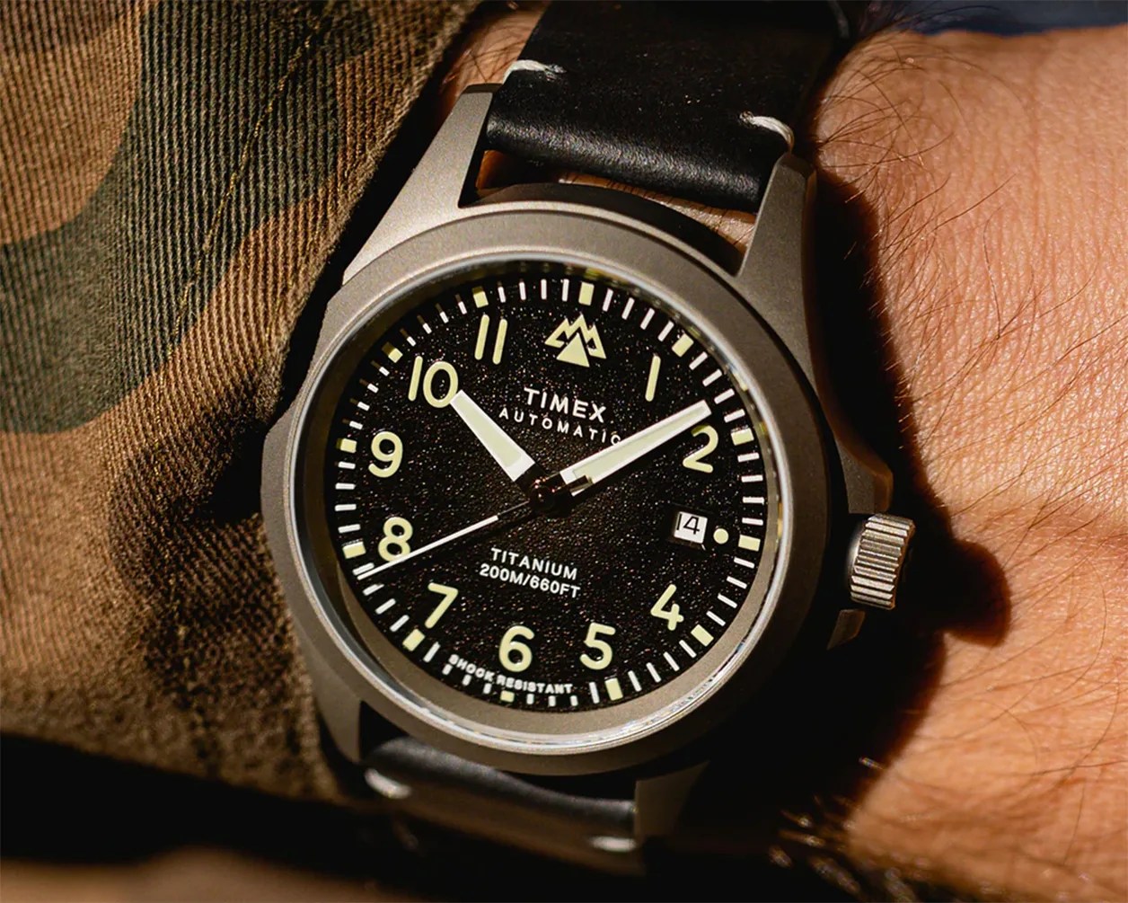 a Timex field watch on a man's wrist
