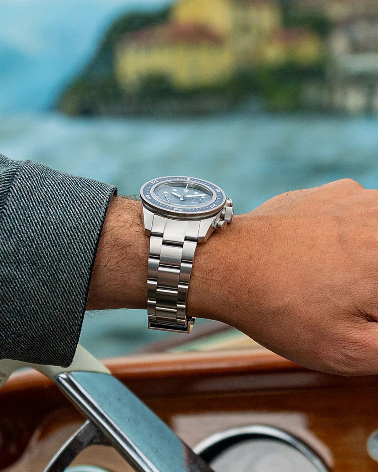 a steel dive watch on a man's wrist