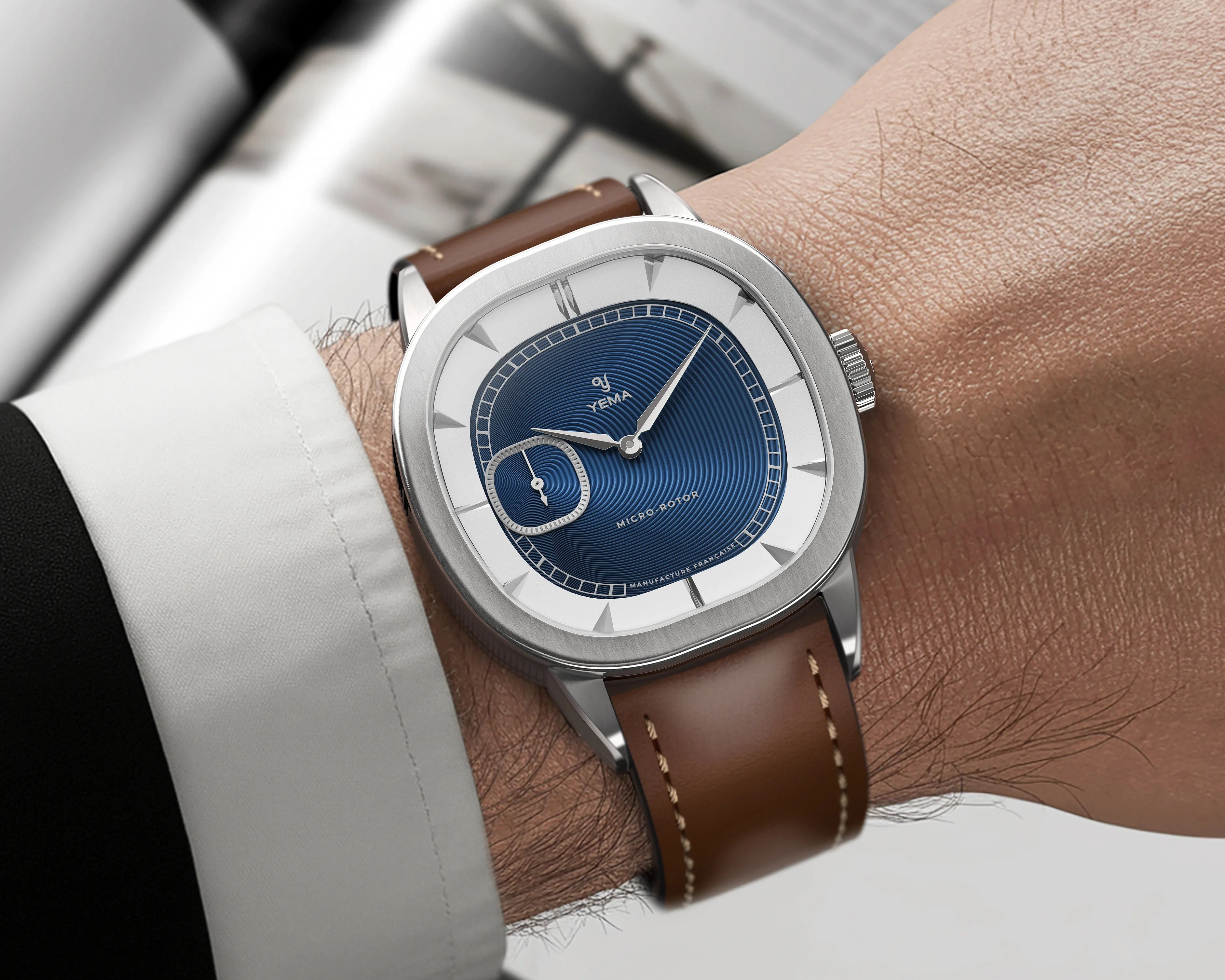 a blue dial Yema dress watch on a man's wrist